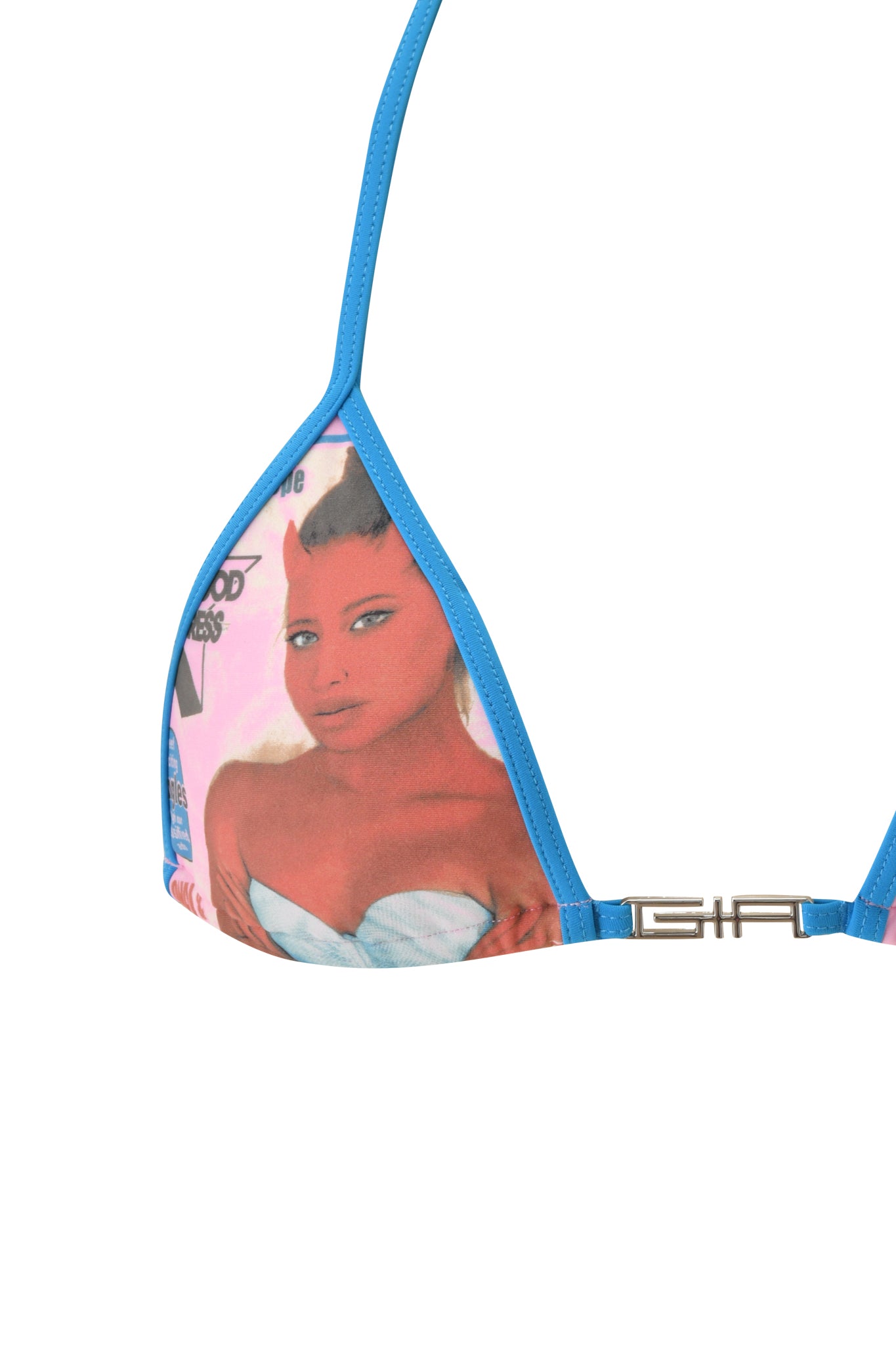 The T-REX AVA BIKINI TOP - PINK from I.AM.GIA is a triangle bikini top with blue trim, featuring a printed image of a red-skinned woman with small devil horns in a white top set against a baby pink background. This striking bikini top is finished with an eye-catching silver "GIA" logo detail for added style.