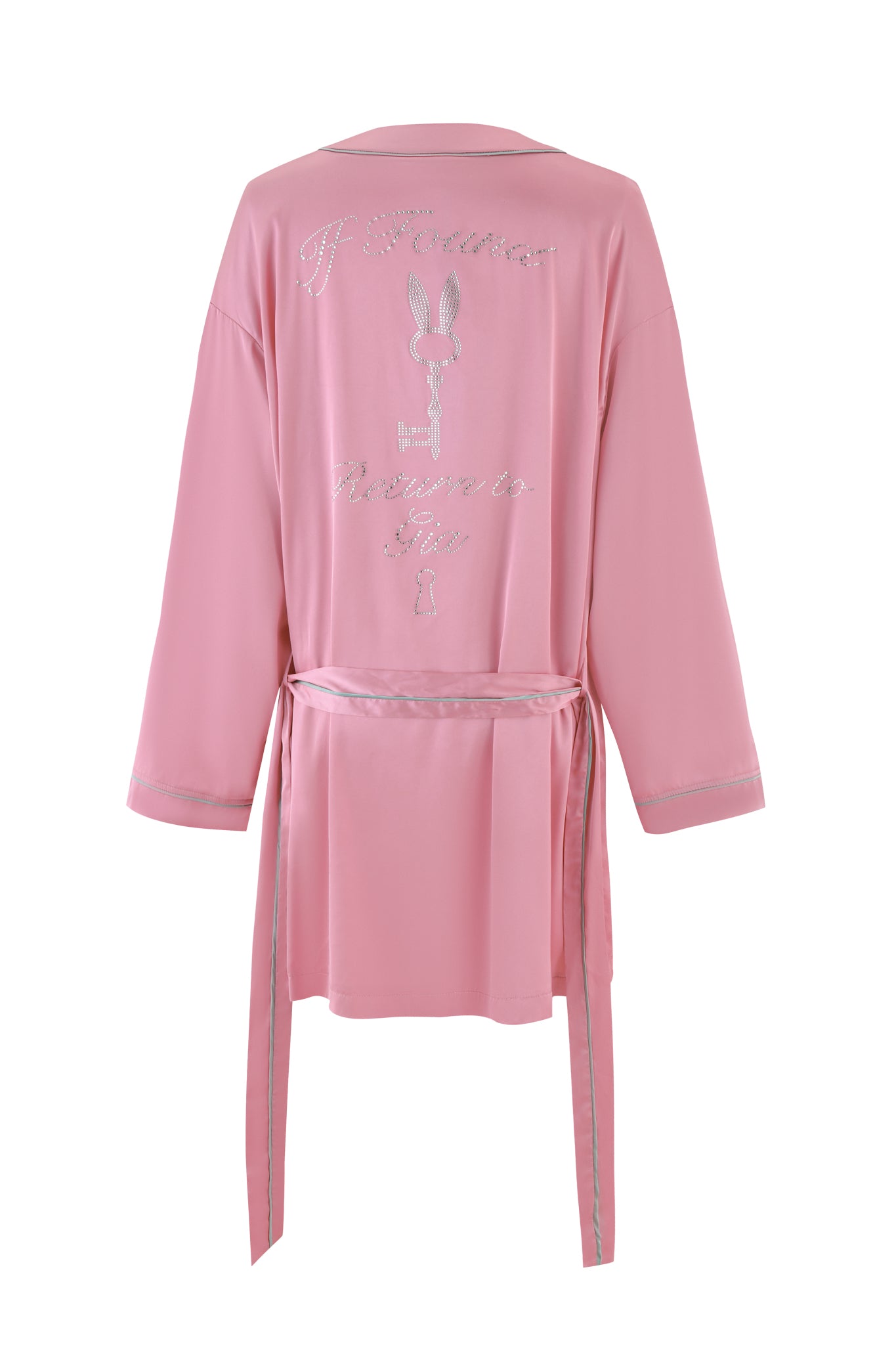 The MARTINA SLEEP ROBE - PINK by I.AM.GIA is a silky satin robe with a silver outline, featuring an embroidered bunny logo and cursive writing on the back that reads "If you want to fly." It offers a relaxed fit with a long belt at the waist and custom 'GIA' diamante embellishments for added sparkle.