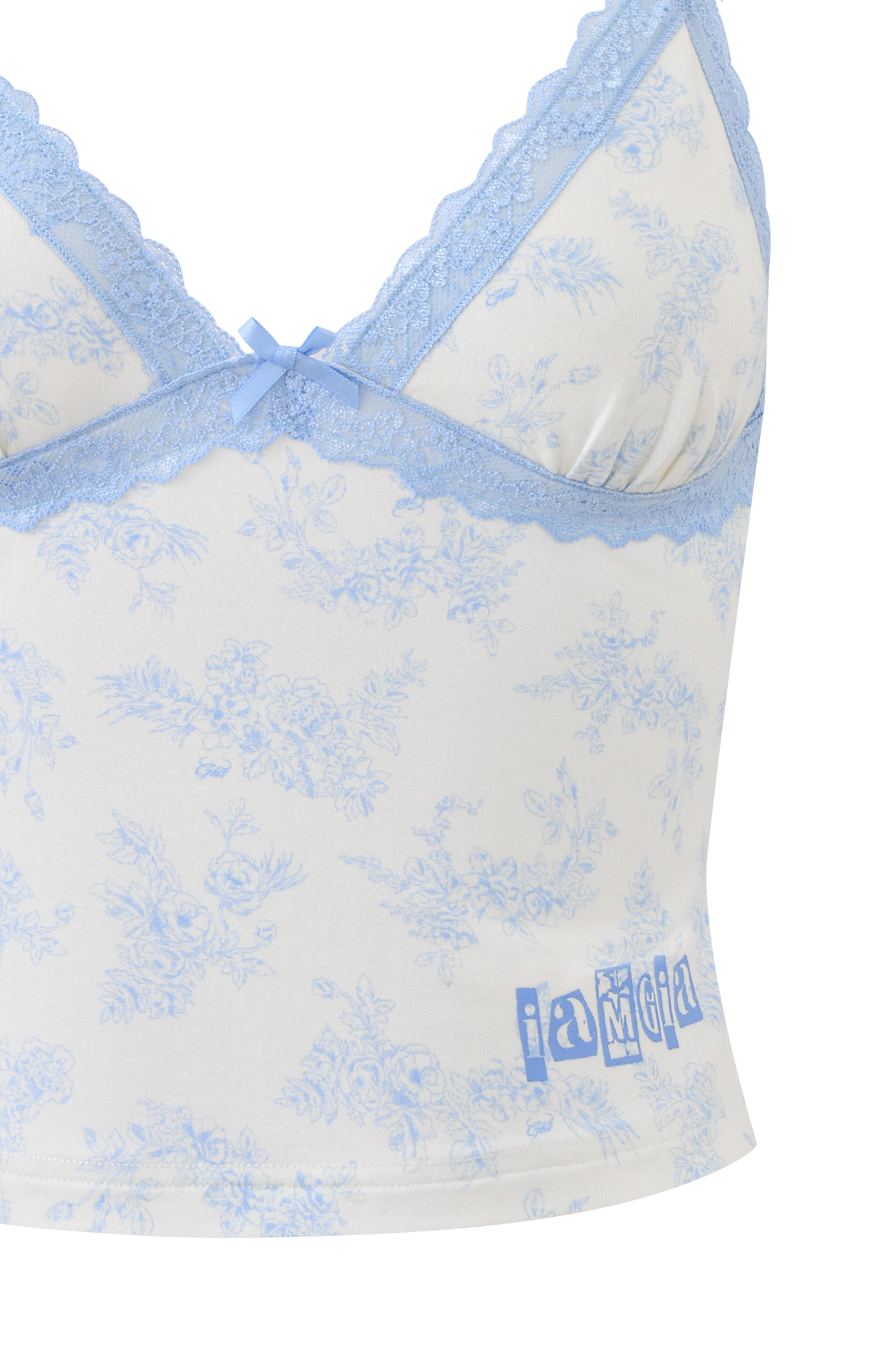 A close-up of the I.AM.GIA KENDRA TANK in blue toile, featuring a white base with light blue floral print, lace-trimmed neckline, adjustable straps, a central bow, and "i am gia" printed at the hem.