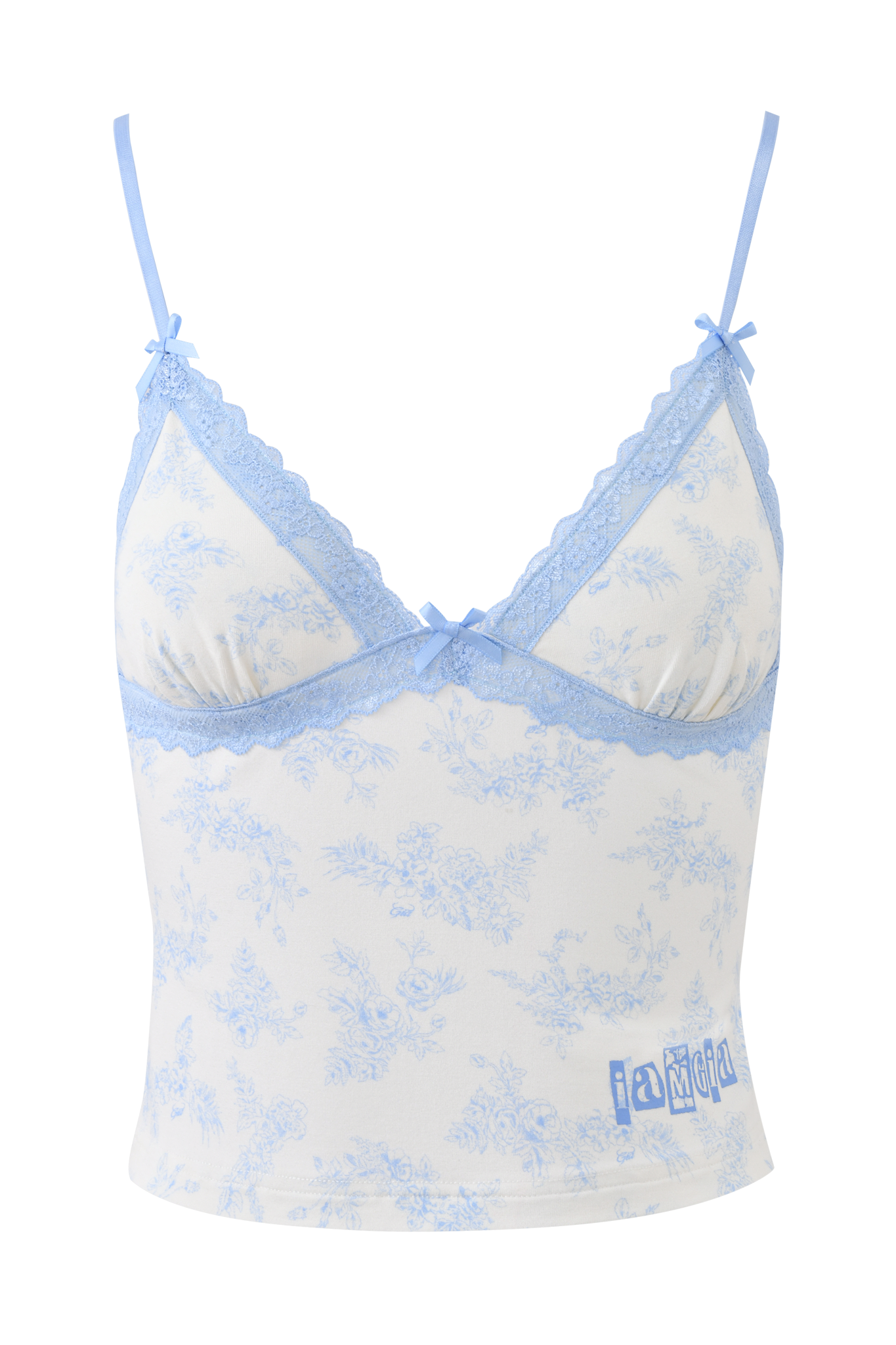 The I.AM.GIA KENDRA TANK - BLUE TOILE is a white camisole with a blue toile floral print, light blue lace trim, bow accents, adjustable straps, and "iamgia" printed in blue on the bottom right.