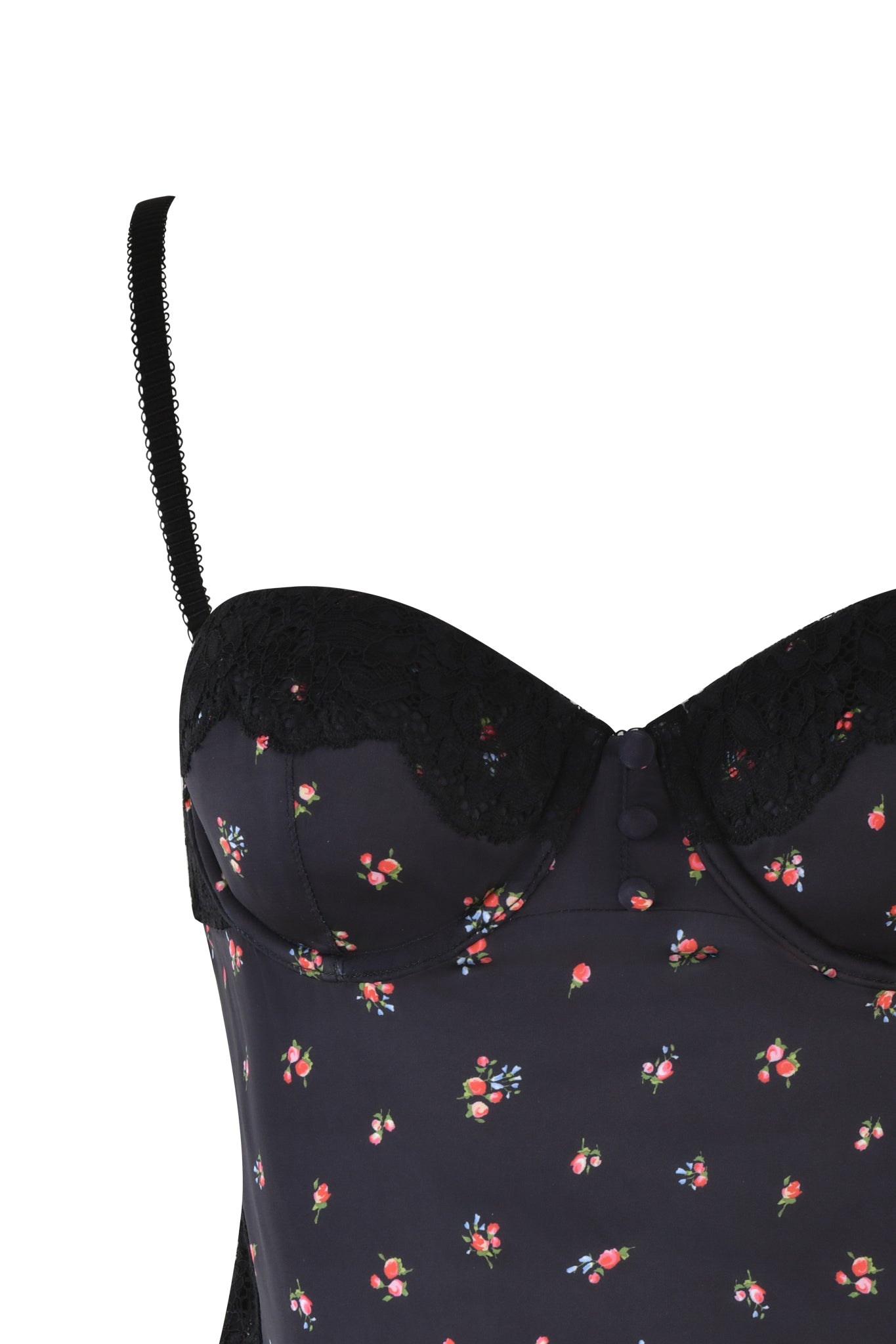 The LUELLA CAMI TOP - BLACK: DITSY FLORAL by I.AM.GIA is a vintage-inspired piece featuring a black bustier with a sweetheart neckline, floral pattern, and lace details. It boasts thin adjustable straps and elegant fabric adorned with delicate red and white flowers.