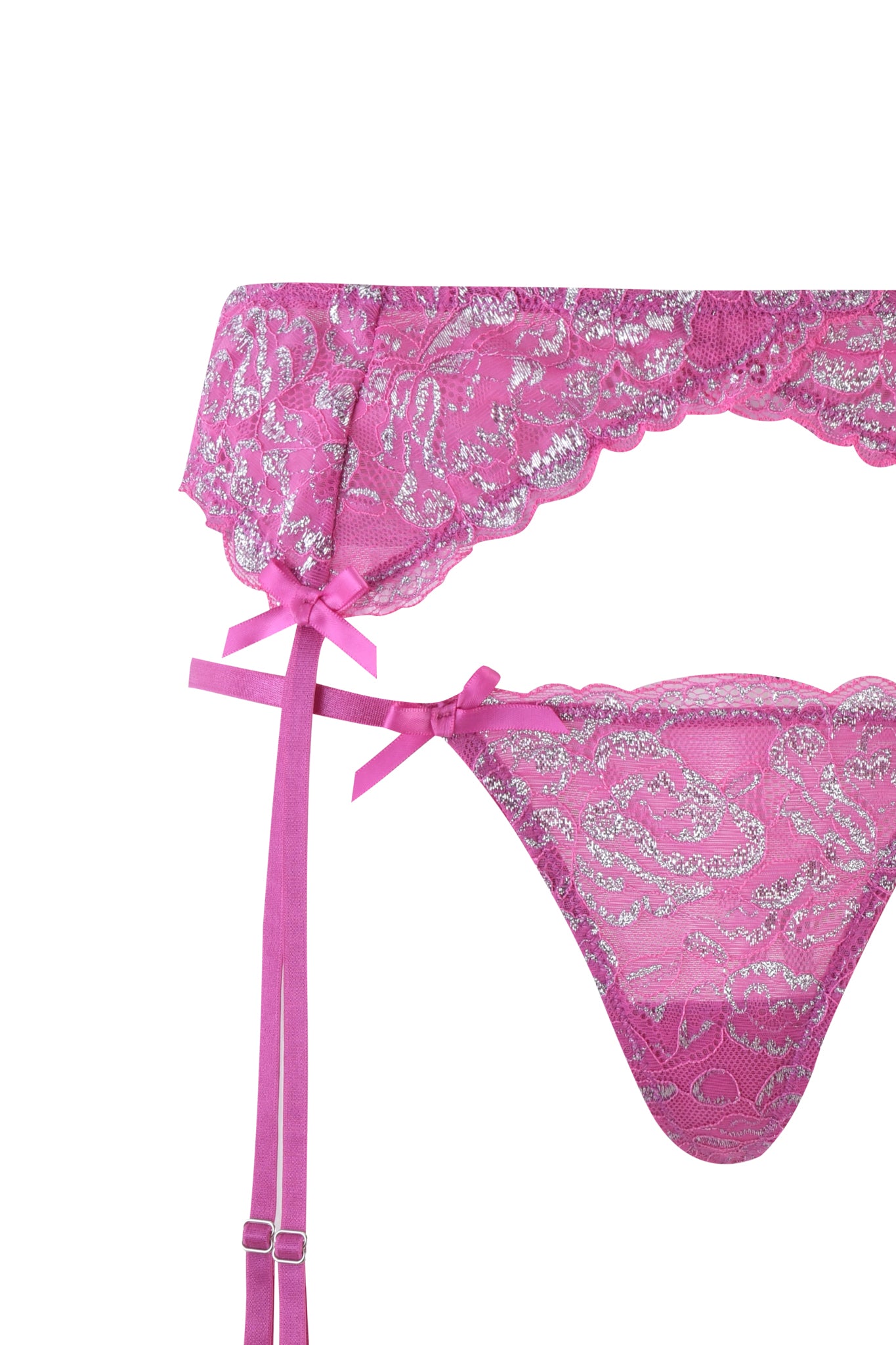 Close-up of the I.AM.GIA RAINE 3 PIECE METALLIC SET in pink, featuring stretch lace with silver floral patterns. The image highlights a garter belt with pink satin bows and a matching thong on a white background, exuding subtle Y2K charm.