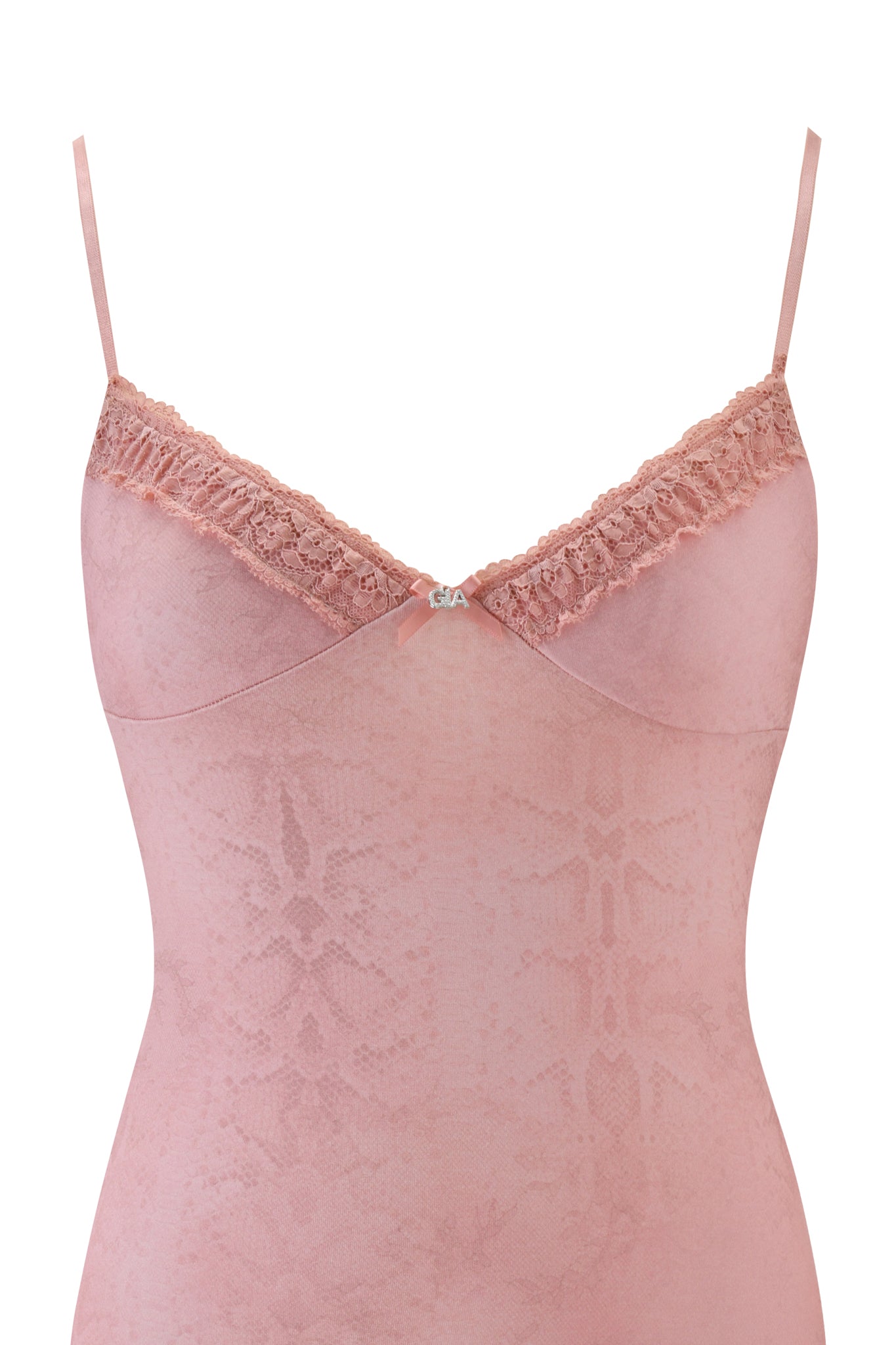 The KISA SLIP DRESS - PEACH SERPENTINE by I.AM.GIA features a light pink serpentine pattern, lace trim, thin spaghetti straps, a small decorative bow at the neckline, and a mini slip silhouette.