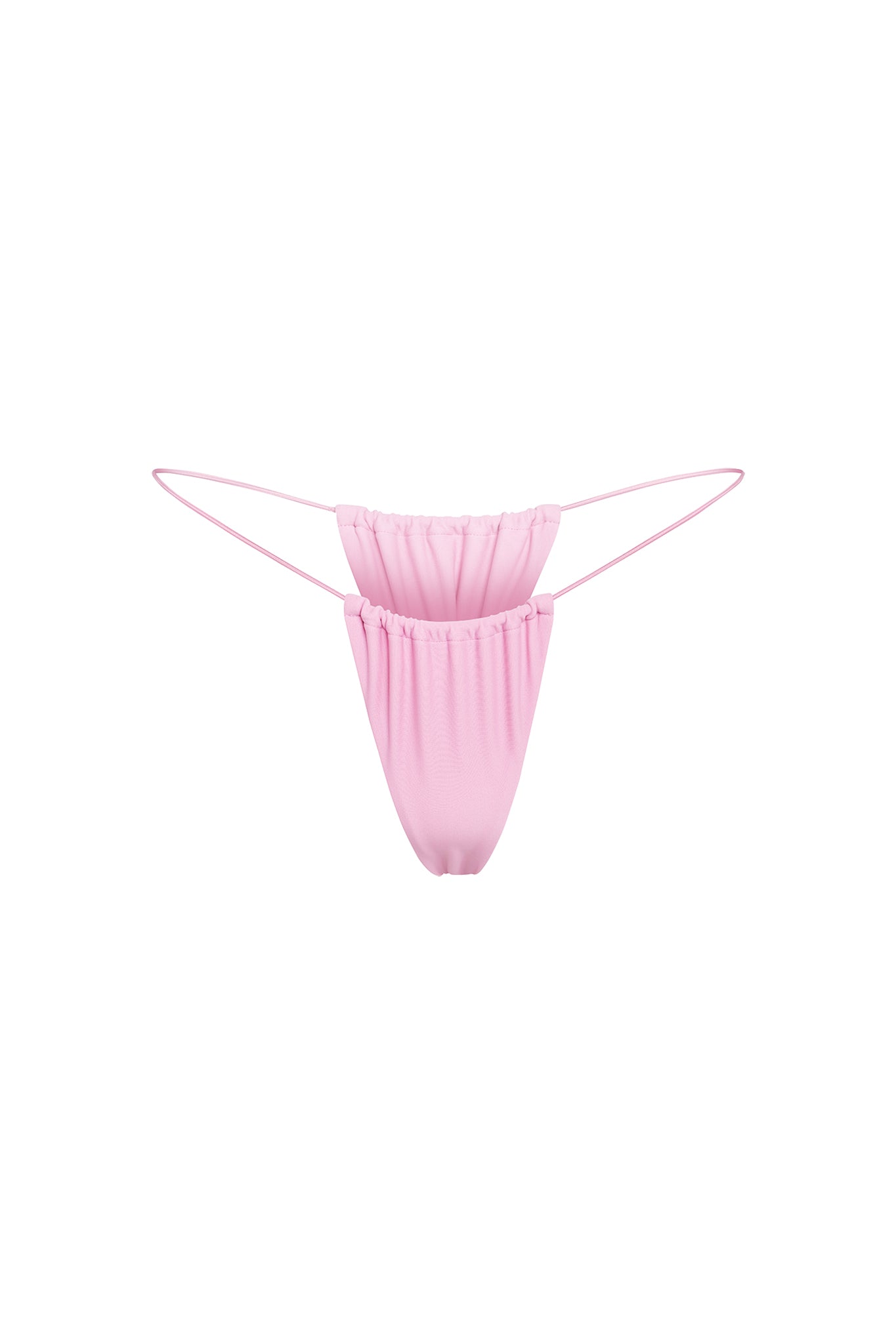 The BAMBI BIKINI BOTTOM - PINK : BUBBLEGUM by I.AM.GIA features a light pink thong design with ruching and thin elastic side straps. The gathered fabric creates a slightly ruffled appearance, offering a delicate and stylish look against the plain white background.