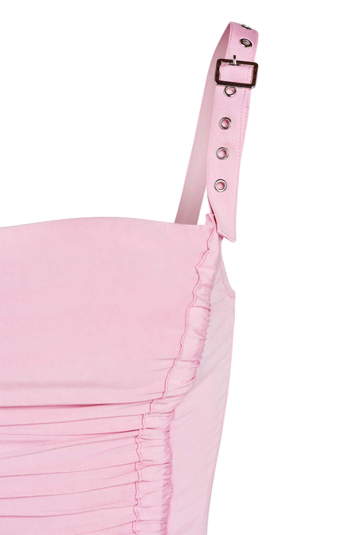 Close-up of the upper portion of the pink LAVINIA TOP from I.AM.GIA, highlighting a single adjustable strap with metal eyelets and a buckle. The top features ruched detailing along the side, set against a plain white background.
