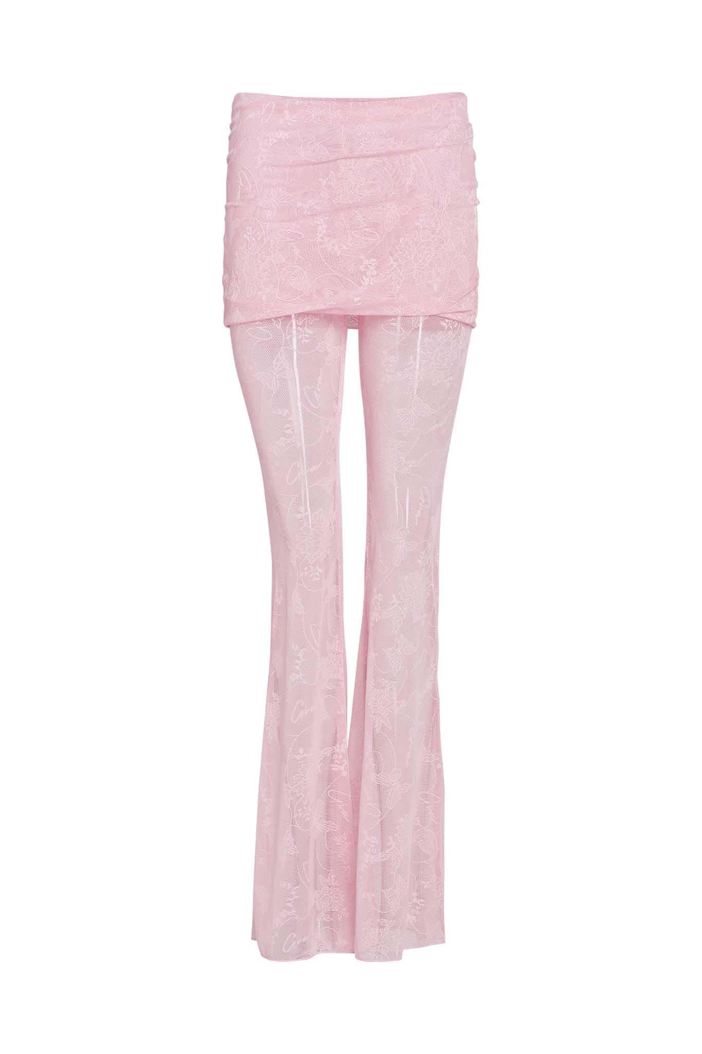 The NALLIAH PANT - PINK : LACE by I.AM.GIA are light pink flared trousers featuring a floral lace pattern. They include a layered, ruched skirt overlay at the waistband for a stylish and unique appearance. These full-length pants have a slightly transparent design.