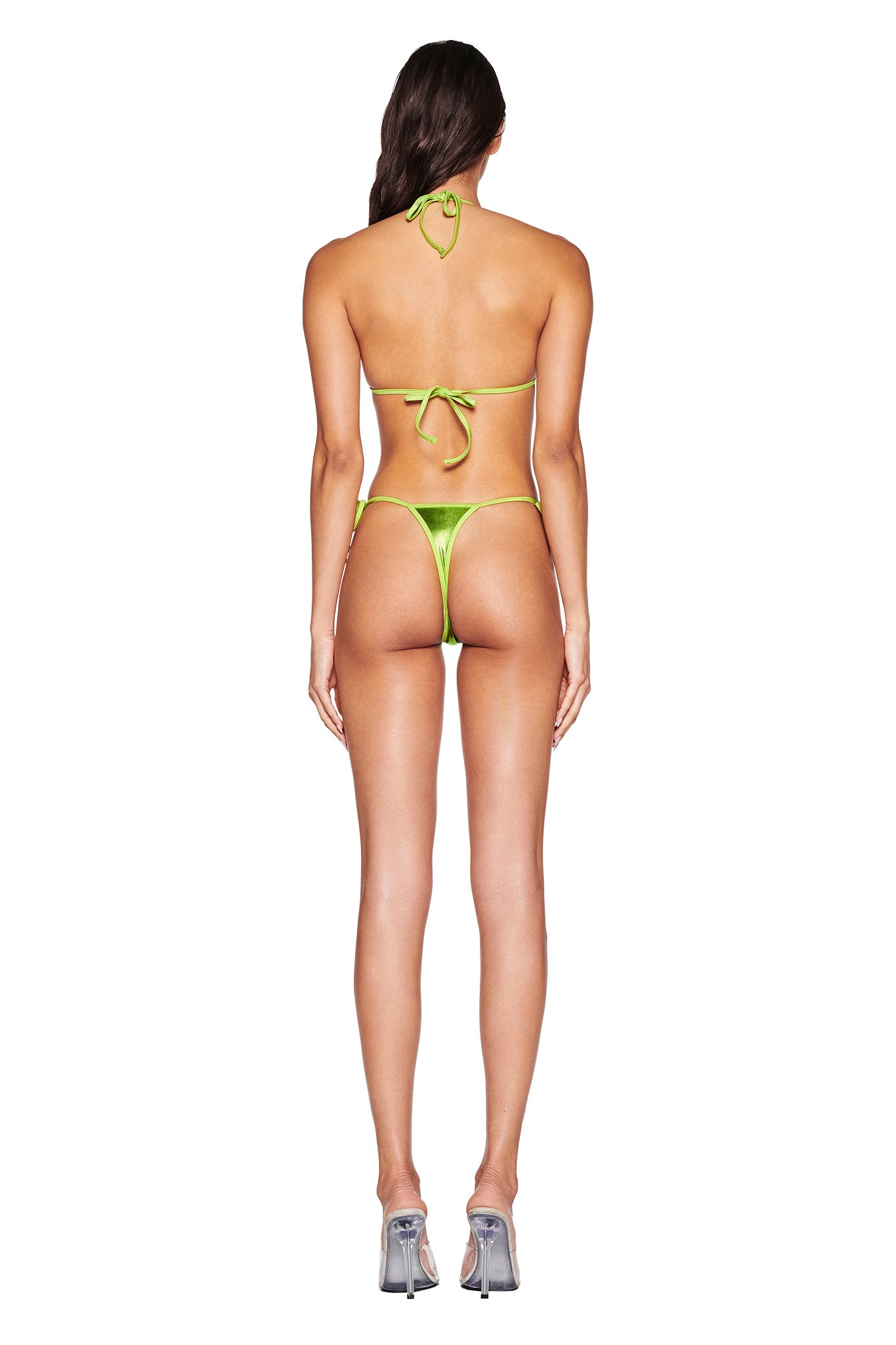 A person with long brown hair wears the I.AM.GIA ALOHI BIKINI TOP in lime green and silver metallic high-heeled shoes, standing against a white background.