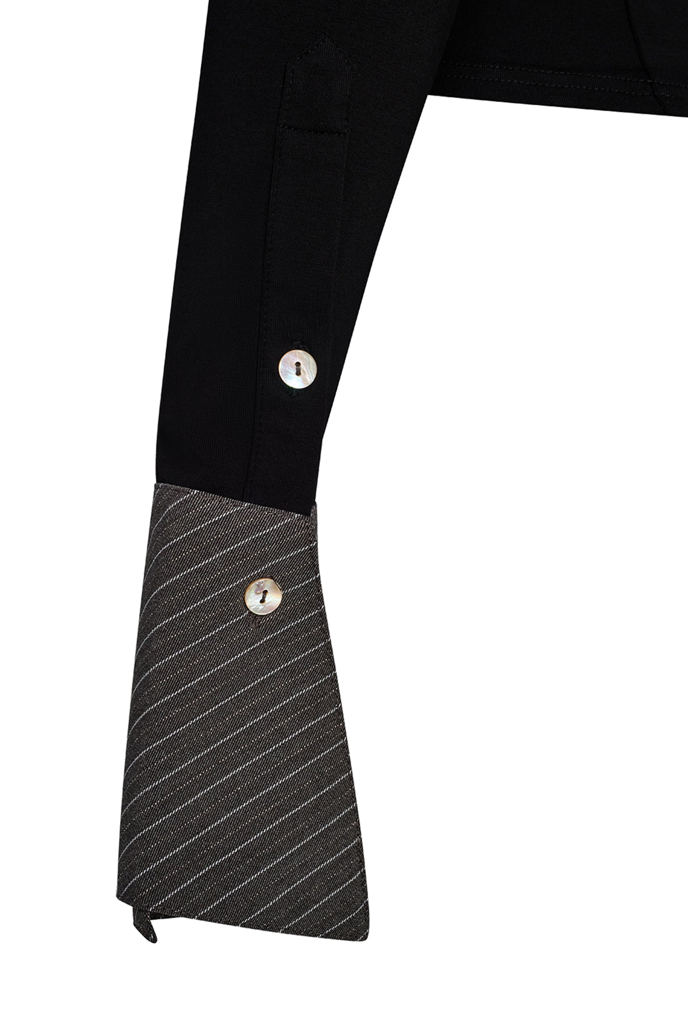 Close-up of the sleeve from the I.AM.GIA SHARAH Top in black and grey, showcasing a cuff with gray and white stripes. The design includes two white buttons: one placed on the cuff and another on a higher diagonal flap. The cuff’s diagonal cut at the end offers a sharp, modern aesthetic.