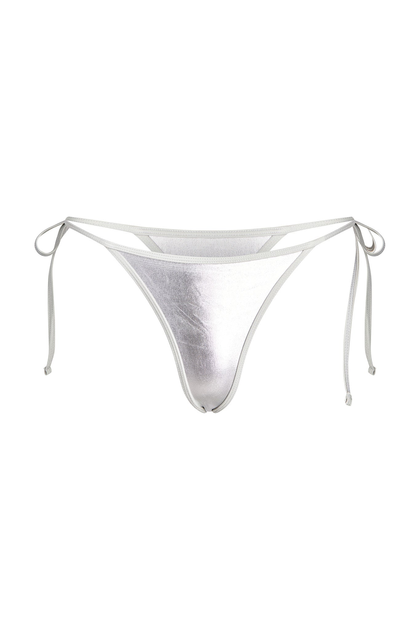 The ALOHI BIKINI BOTTOM - GREY : SILVER by I.AM.GIA features a pair of silver, metallic thong bottoms with thin string ties on the sides. The design is minimalistic, featuring a high-cut leg and a shiny finish that reflects light. The strings are tied in small bows, adding a delicate touch to the overall I.AM.GIA-inspired look.