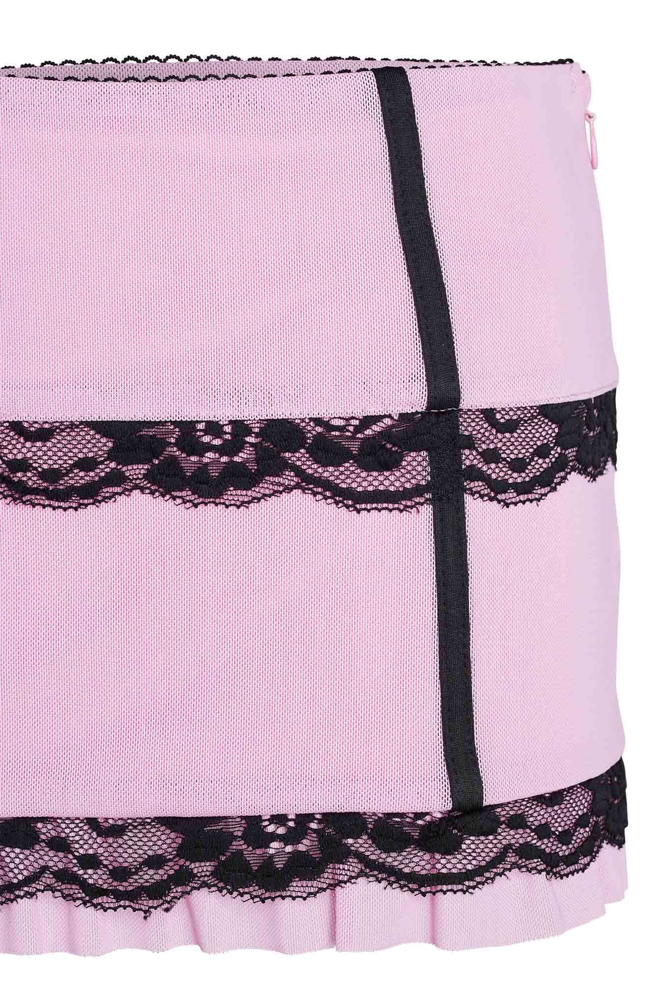 Close-up of the SUTRA SKIRT - PINK by I.AM.GIA featuring black lace and ribbon details. The design includes a band of black lace near the top and bottom, with a black ribbon running vertically, creating an elegant and feminine appearance.