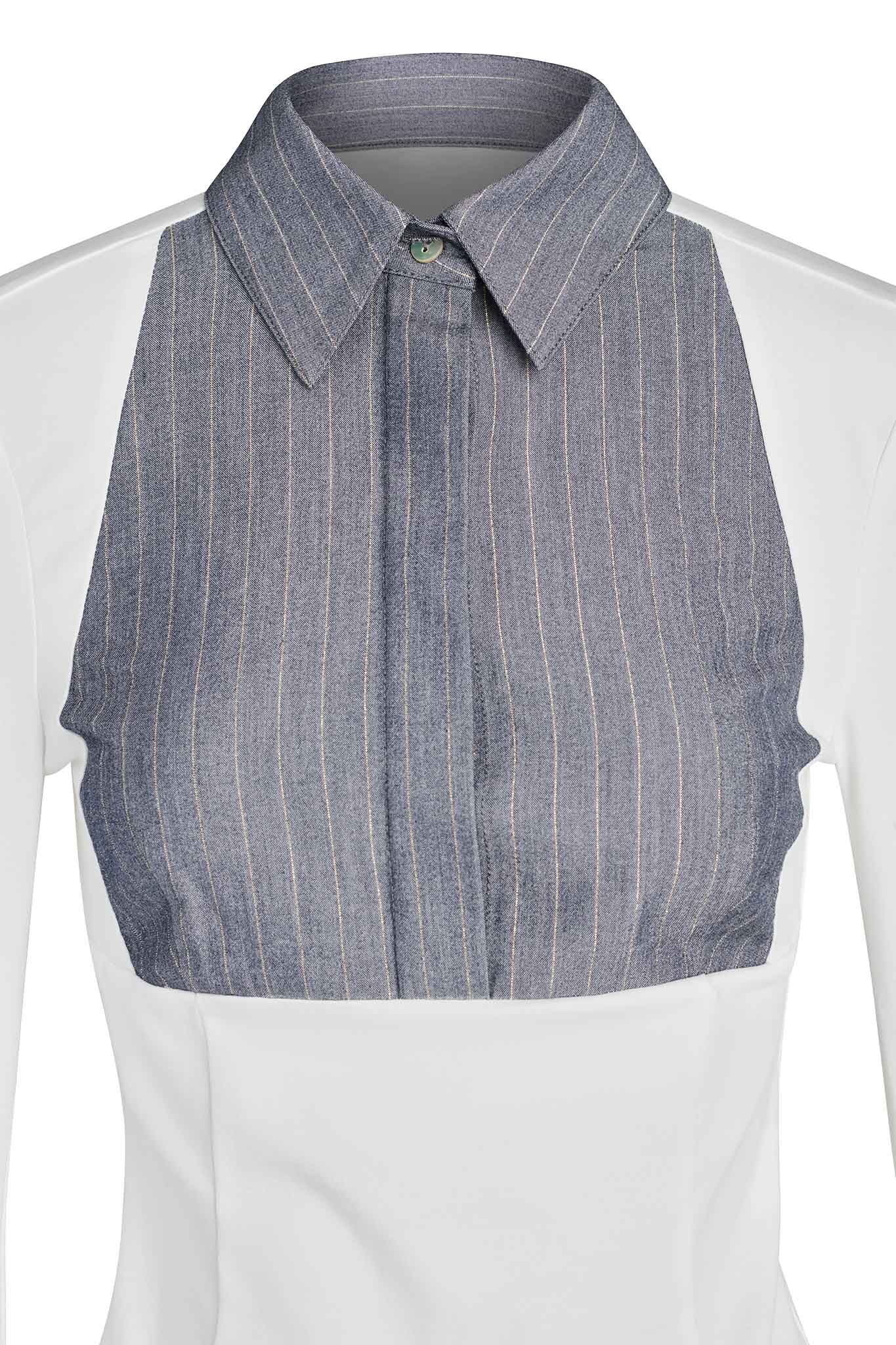 A close-up of the SHARAH TOP - WHITE by I.AM.GIA, showcasing its distinct design. The upper chest area features a gray pinstripe panel with vertical lines and a single button at the collar. The rest of the shirt is white, creating a striking contrast with the patterned panel. Long sleeves further highlight I.AM.GIA's unique style.