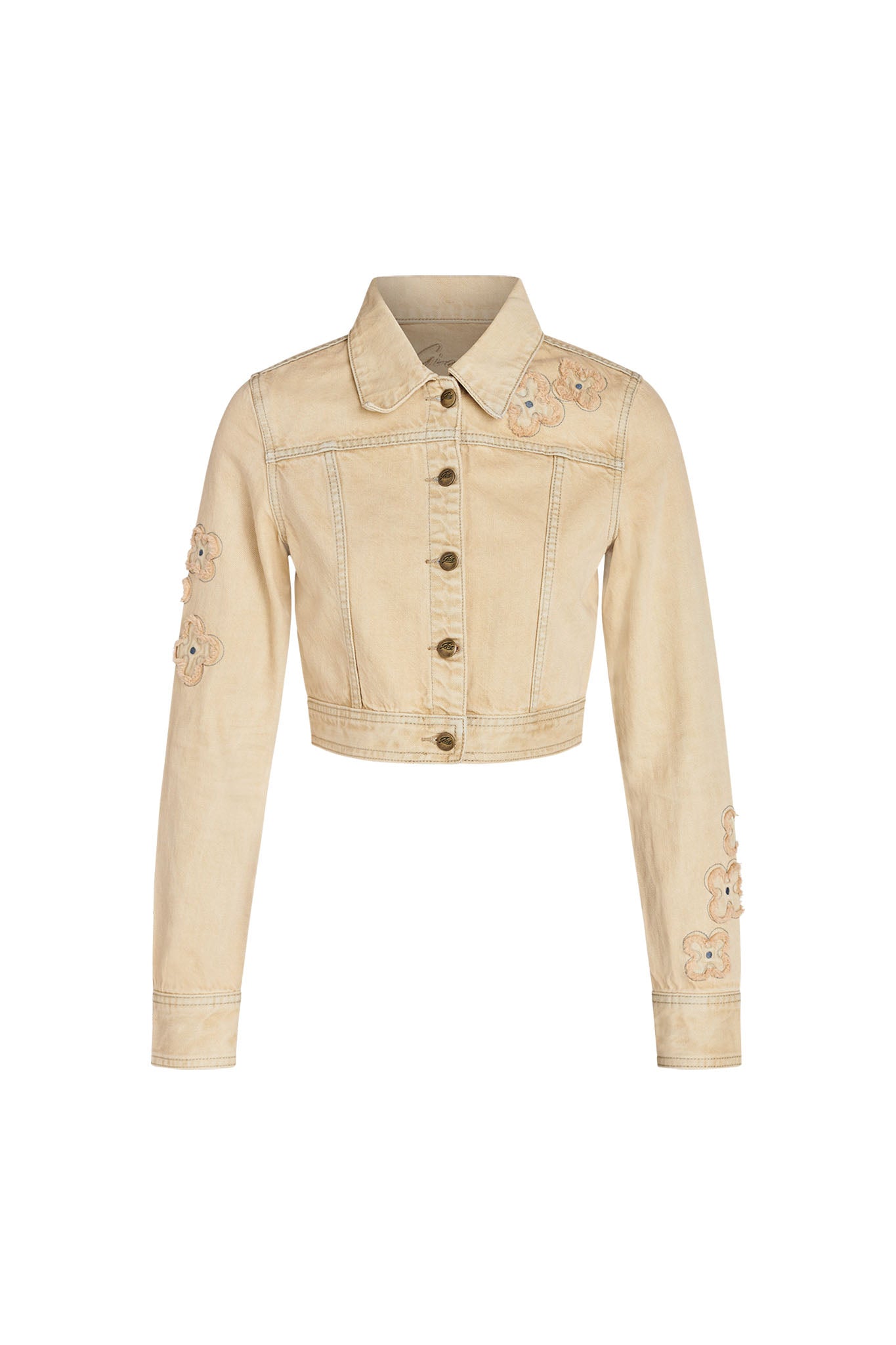 The FAUNA JACKET - BEIGE : TAN DENIM by I.AM.GIA is a beige, cropped denim jacket with long sleeves. It features metal buttons down the front and is decorated with small floral embroidery on the left shoulder and both sleeves.