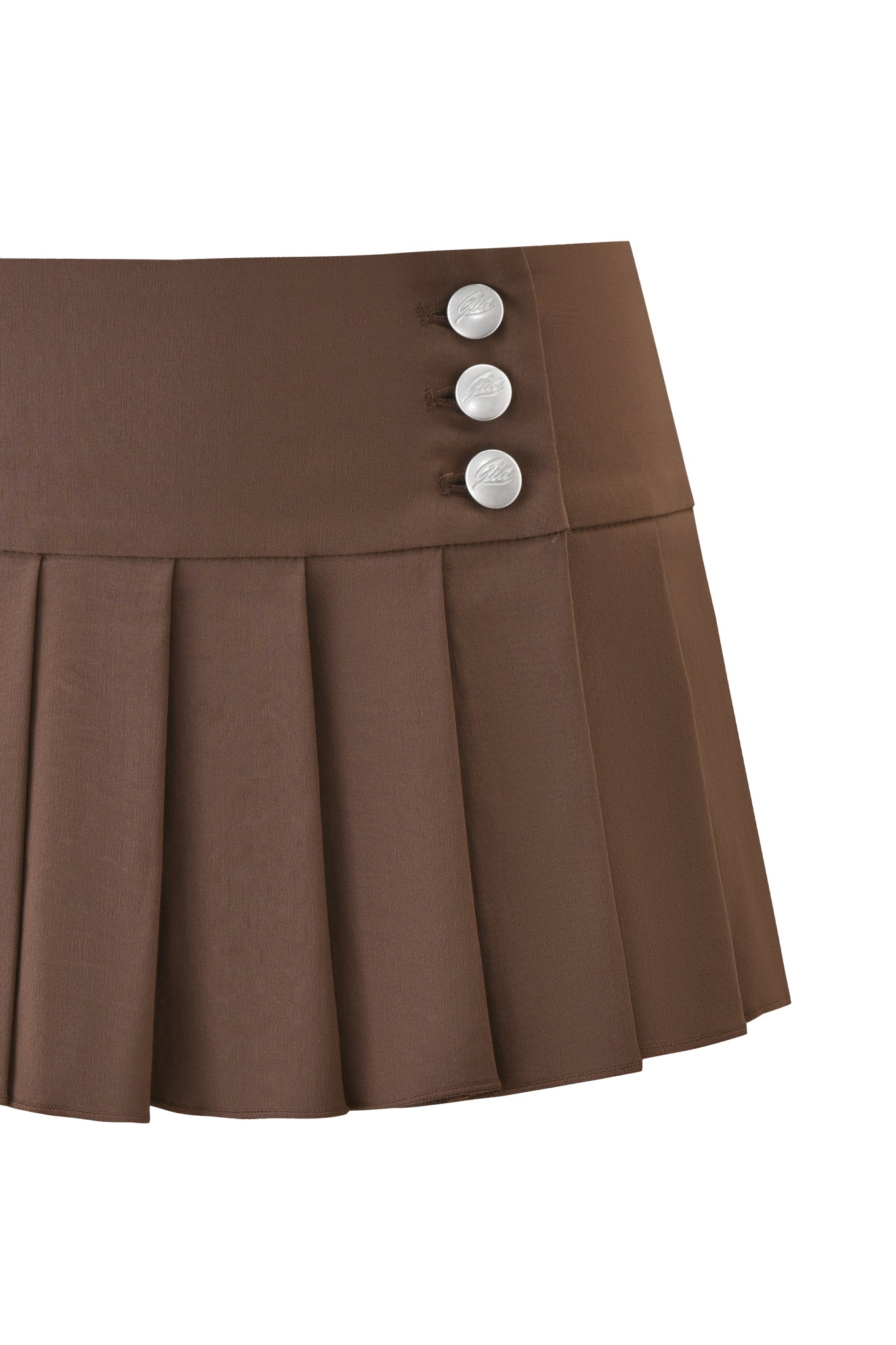 The REMINI SKORT - BROWN by I.AM.GIA is a chocolate brown micro mini skirt with pleats and three silver buttons on the left waistband, shown against a white background.