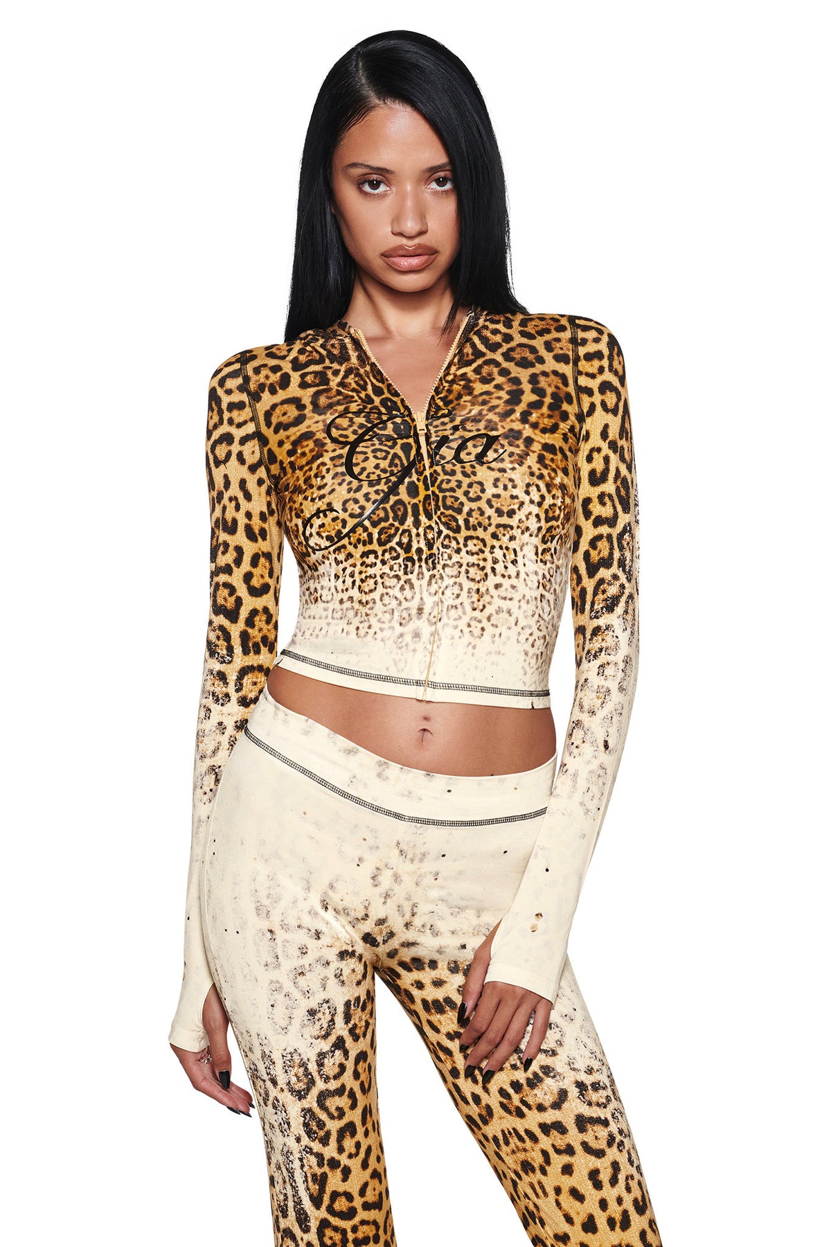 A model wears a cropped, zip-up I.AM.GIA BLARE HOODIE - CREAM FADED PANTHERA that fades from brown at the top to cream at the waist, with “Gia” written in cursive script on the chest.