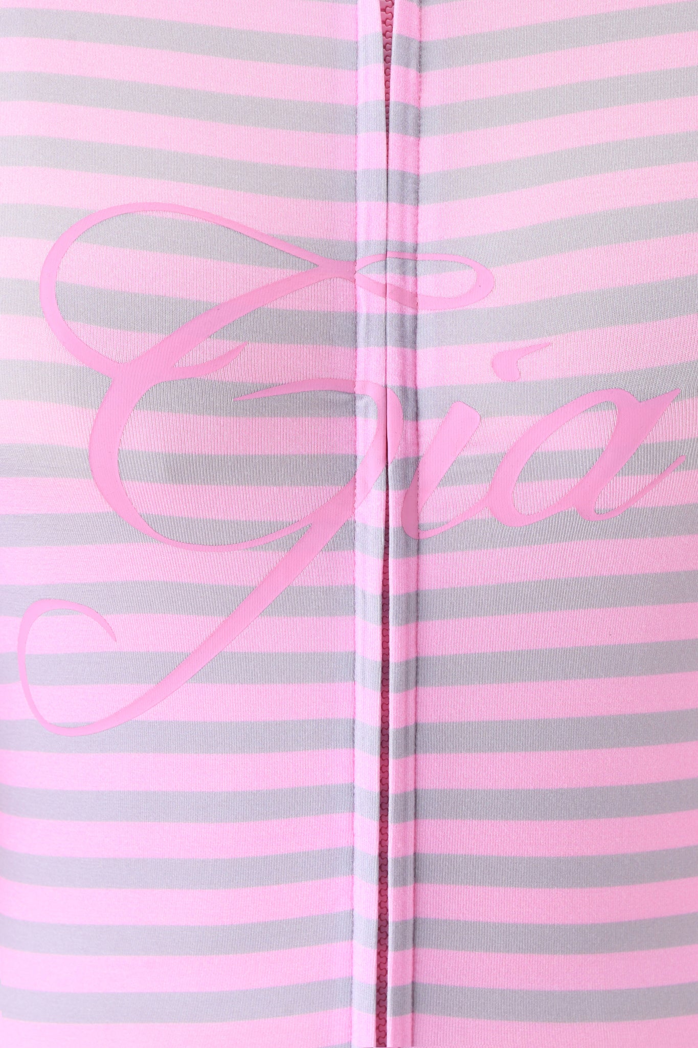 The I.AM.GIA BLARE HOODIE - LIGHT PINK STRIPE features pink and gray horizontal stripes with a center vertical seam and faint oversized pink cursive text partially visible across the middle.