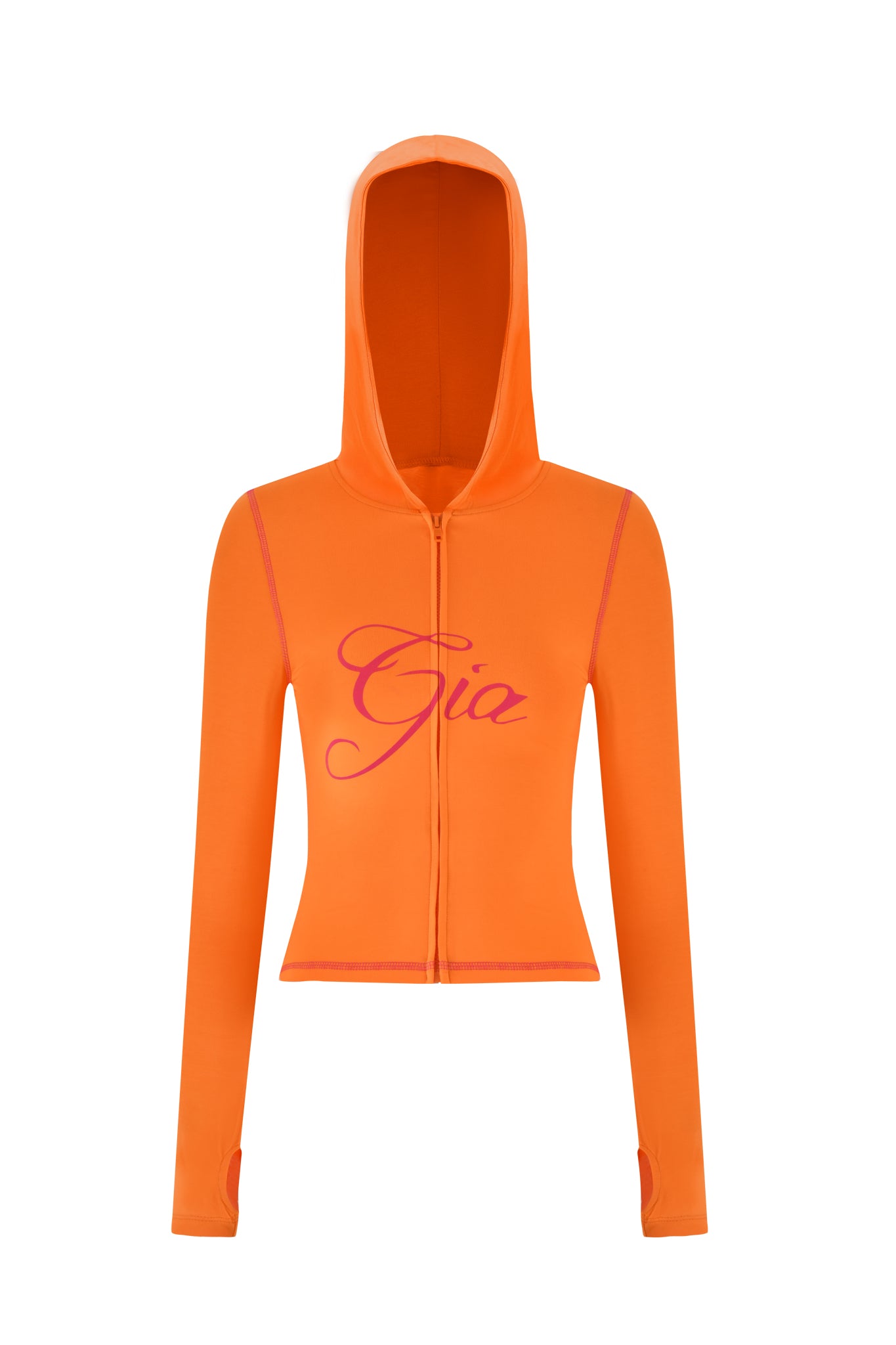 The BLARE HOODIE - ORANGE by I.AM.GIA features a bodycon silhouette, long sleeves with thumb holes, and a large hood. It sports eye-catching pink "Gia" text on the front. The fabric is smooth and fitted in a trendy orange colorway for added comfort and style.