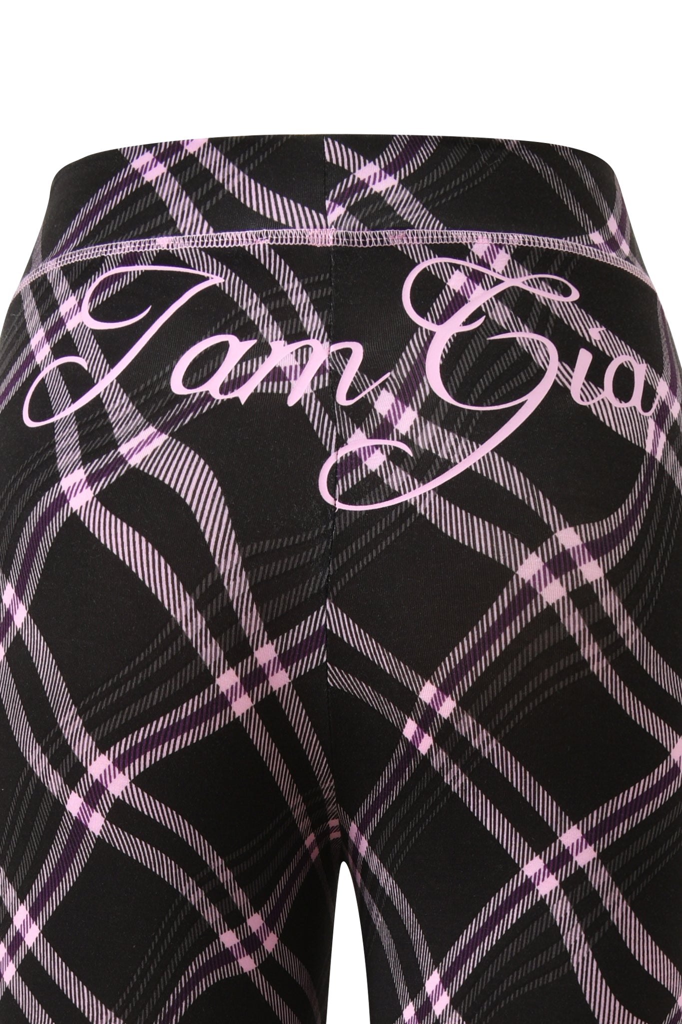 Close-up of I.AM.GIA BLARE TRACKPANT in black warped plaid, featuring a bold pink plaid design and "I am Gia" in large cursive across the back.