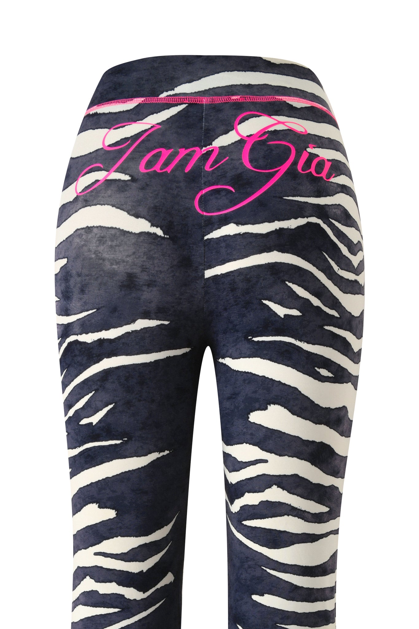 The BLARE TRACKPANT - BLACK WILD SIDE by I.AM.GIA features a bold zebra print and a flattering mid-rise waist, with “I.AM.GIA” written in pink cursive across the waistband for everyday comfort.