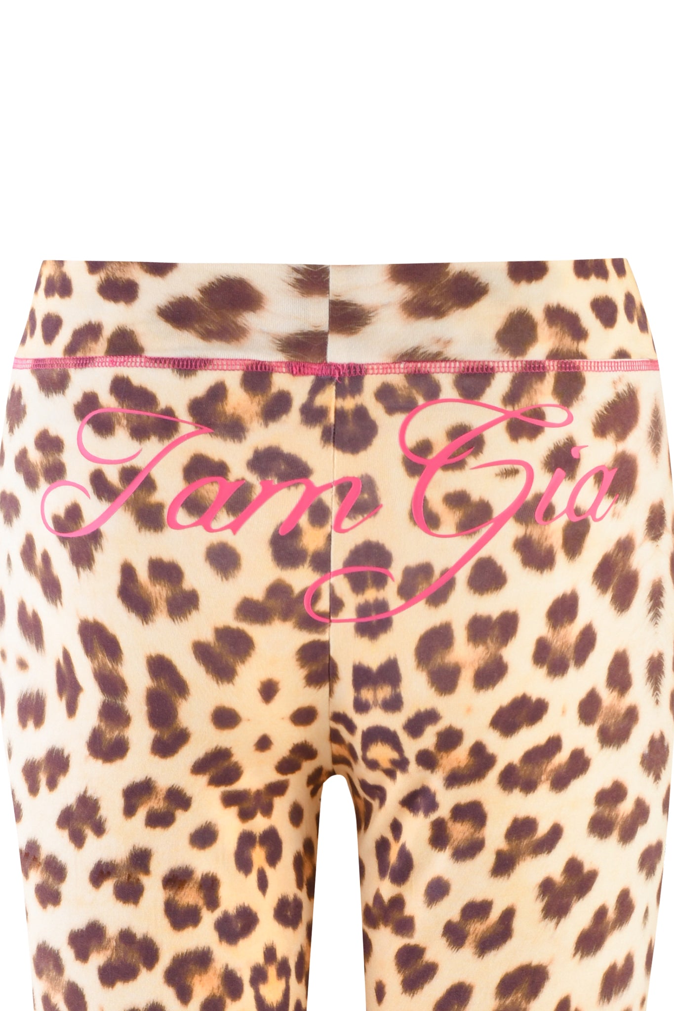 A close-up of the BLARE TRACKPANT - NEUTRAL : LEOPARD : WILD CARD showcasing a custom leopard print pattern of brown and black spots on a beige background. "I.AM.GIA" is written in pink cursive across the back waistband, crafted from stretchy bamboo fabrication for ultimate comfort.