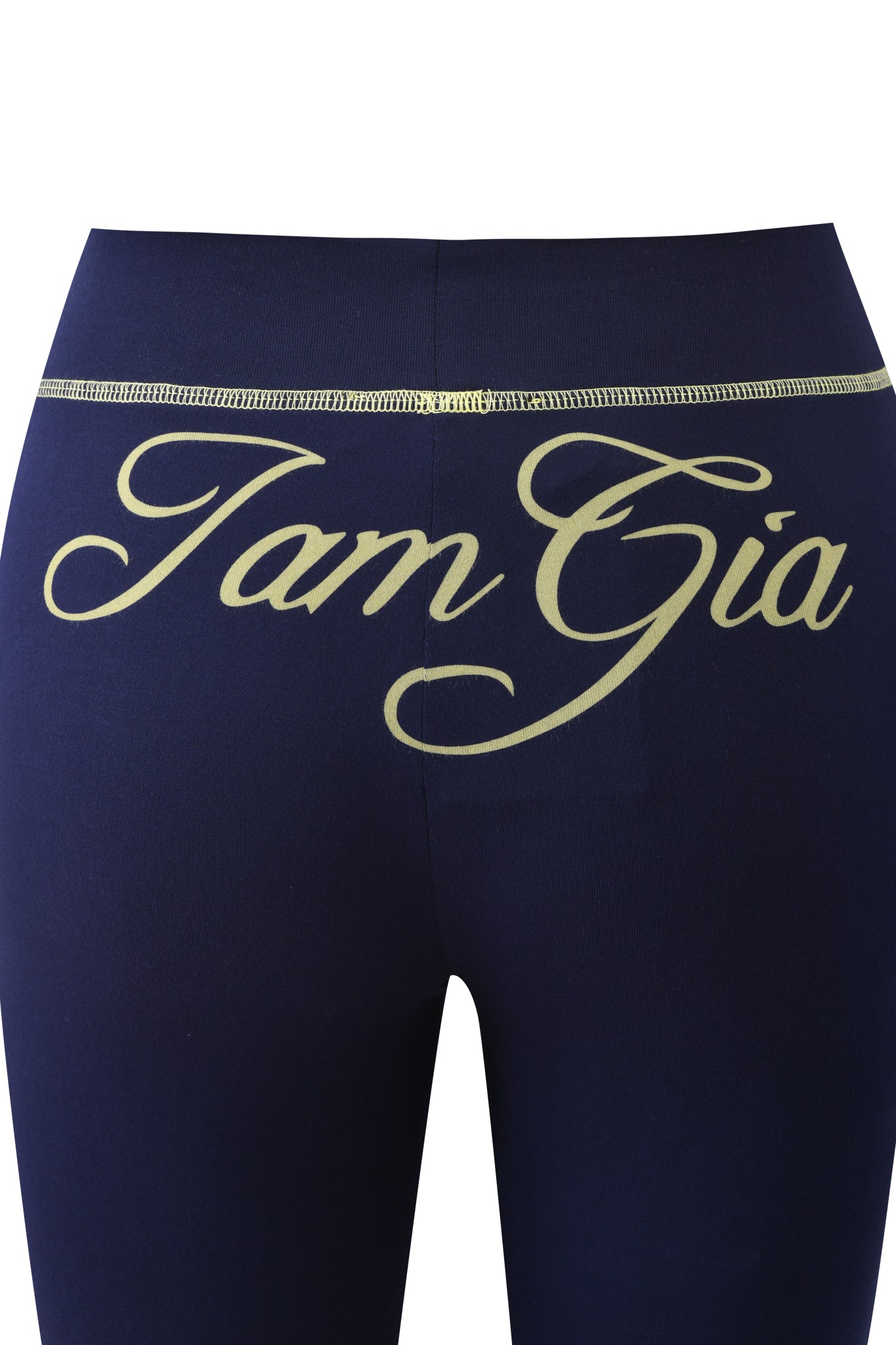 The BLARE TRACKPANT - NAVY by I.AM.GIA features flared legs and bold cream "I.AM.GIA" lettering in cursive across the waistband and upper hips, offering a stylish update to your casual look.