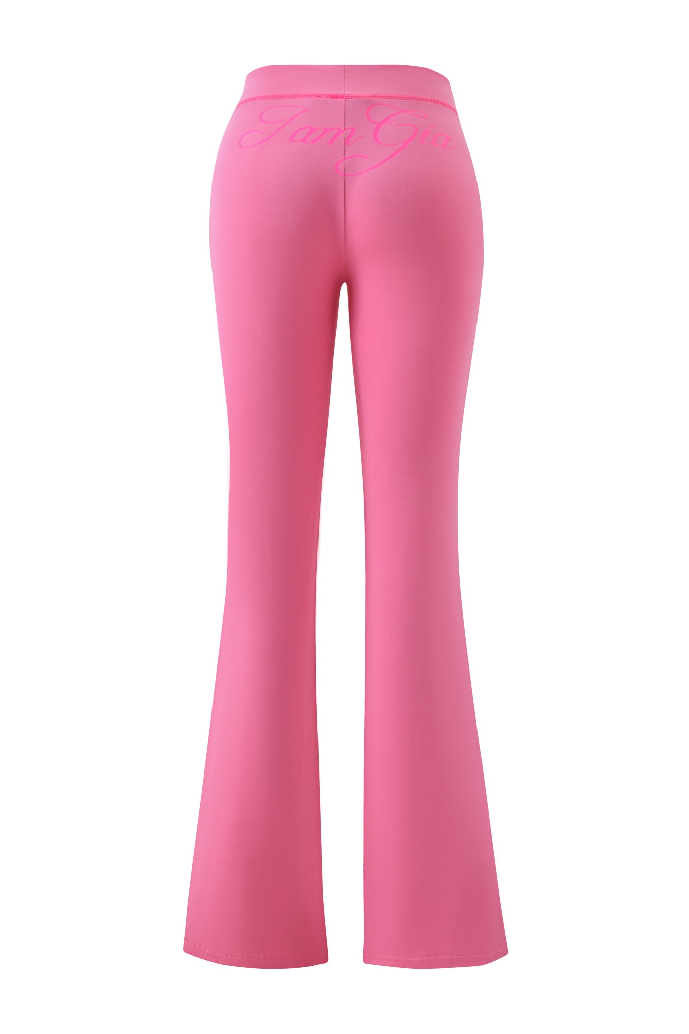 The BLARE TRACKPANT - NEON PINK by I.AM.GIA is shown from the back, featuring a high-waisted flared cut and "I.AM.GIA" in cursive across the waistband.