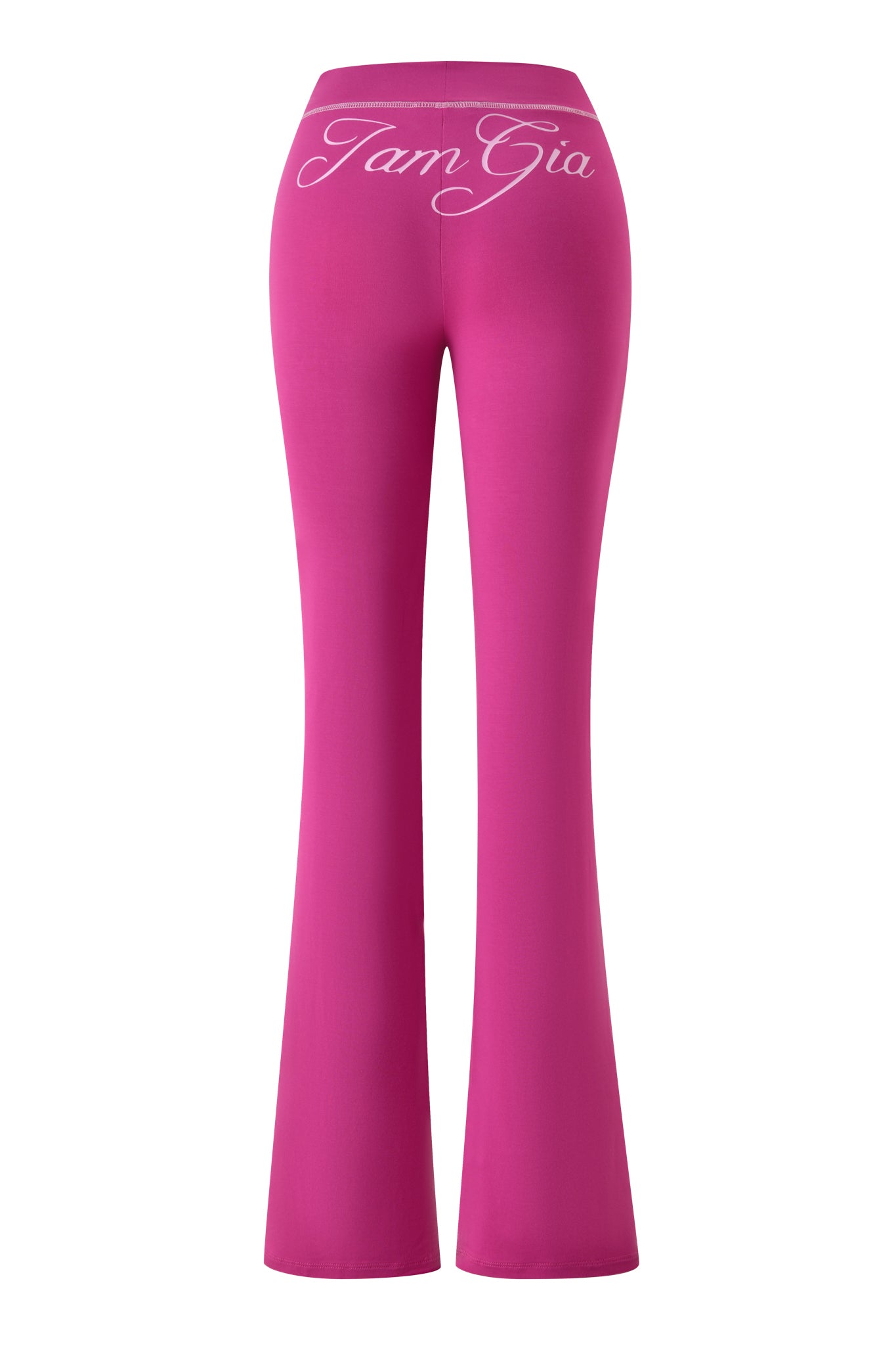 The BLARE TRACKPANT - RASPBERRY by I.AM.GIA features bright pink, high-waisted flared legs with "I.AM.GIA" in large white script on the back waistband—a bold statement piece.