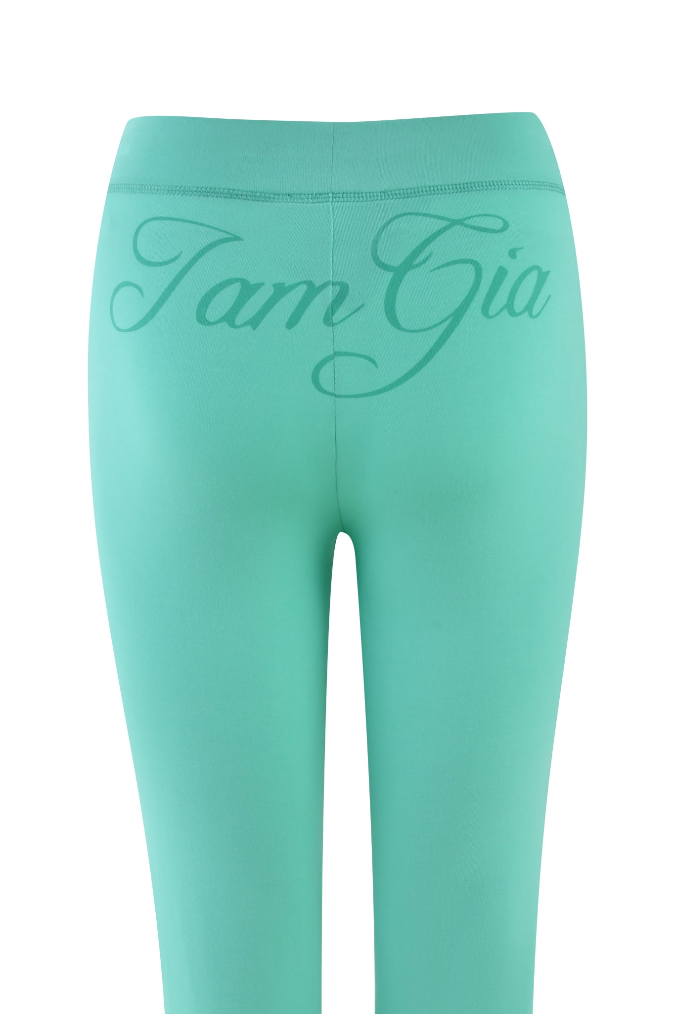 The BLARE TRACKPANT in turquoise teal by I.AM.GIA features "Iam Gia" in cursive on the waistband. The stretchy bamboo fabric looks smooth and form-fitting against a plain white backdrop.