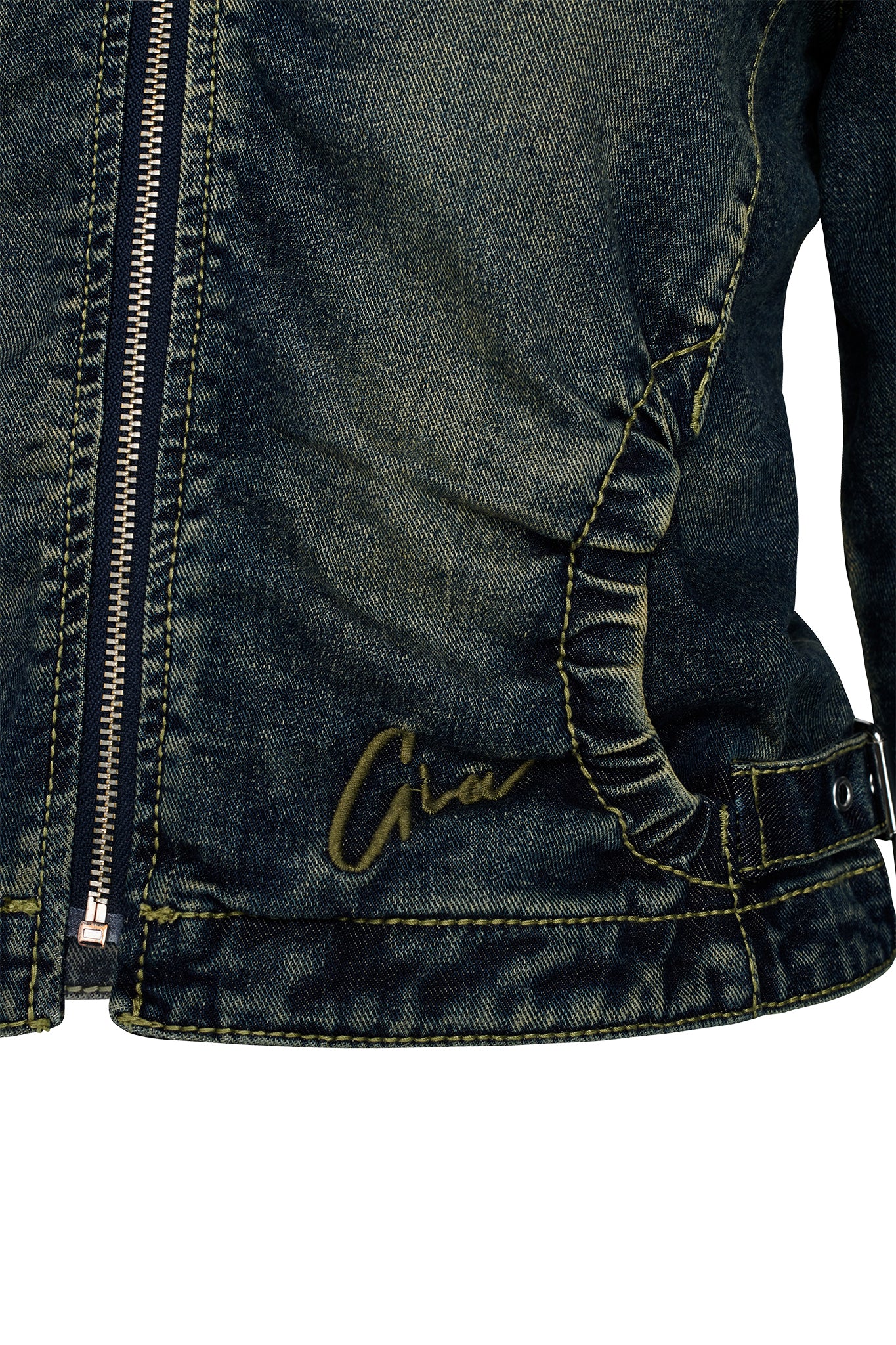 A close-up of the NYKKO JACKET - BLUE by I.AM.GIA showcases its dark wash denim fabric with prominent yellow stitching. The jacket includes a distinctive zipper on the left side and an embroidered I.AM.GIA signature in cursive on the bottom left. The material has a subtly worn texture, complemented by a buttoned strap on the lower right edge.