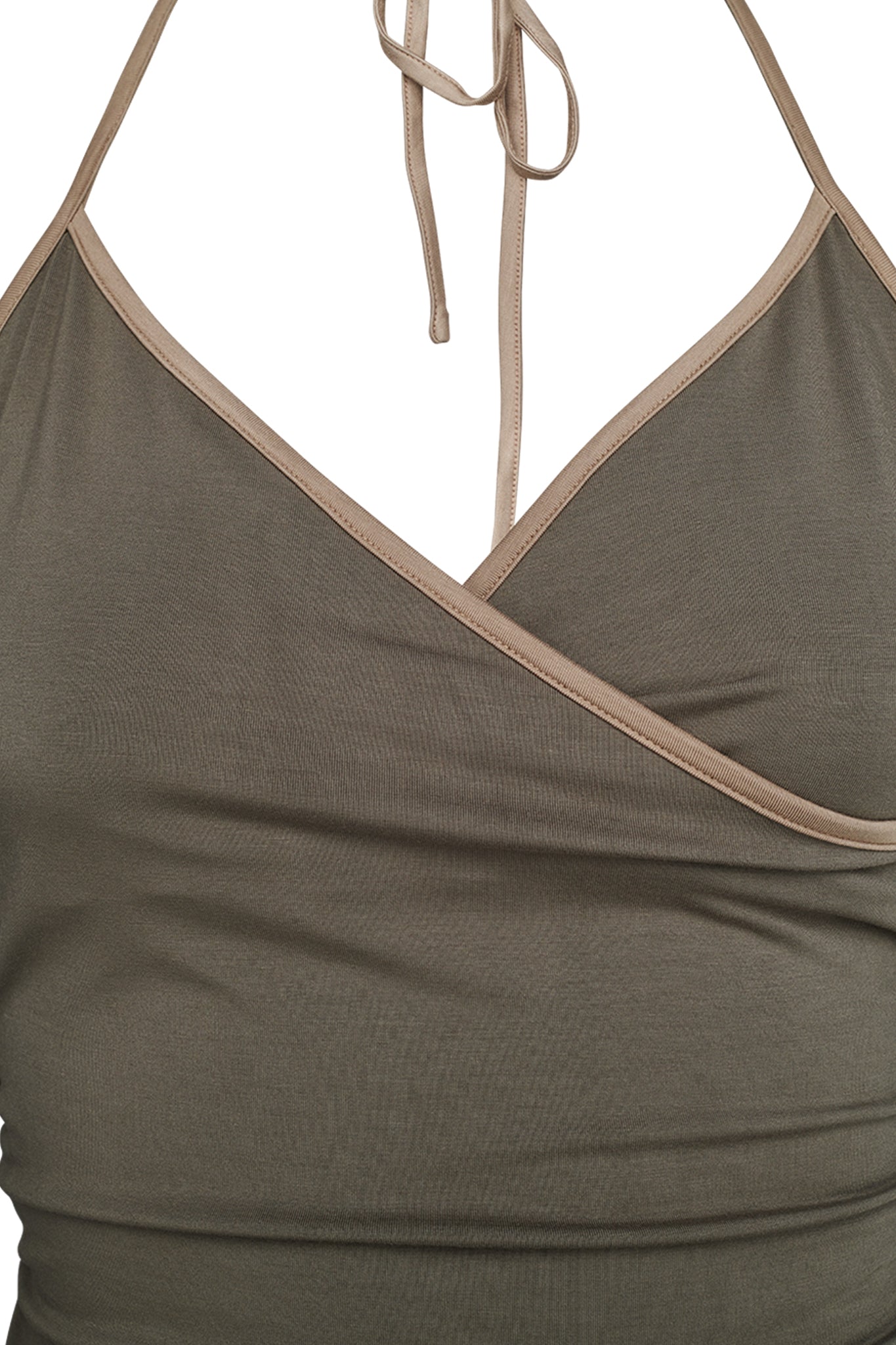 Close-up of a person's torso wearing the I.AM.GIA JANNIS TANK in olive green. The neckline is a V-shape with beige trim, and the fabric features a slight ruched effect on one side. The halter strap is tied behind the neck.