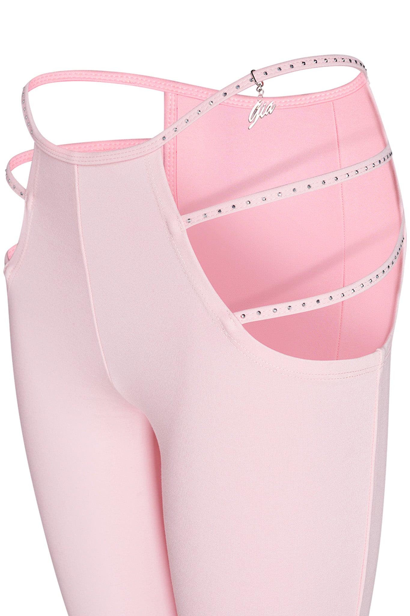 The Roxanna Pant in Baby Pink by I.AM.GIA is a pair of pink leggings featuring cut-out side details adorned with rhinestones and an attached charm. Its unique design includes multiple thin straps around the hip area, giving it a fashionable and edgy appearance.