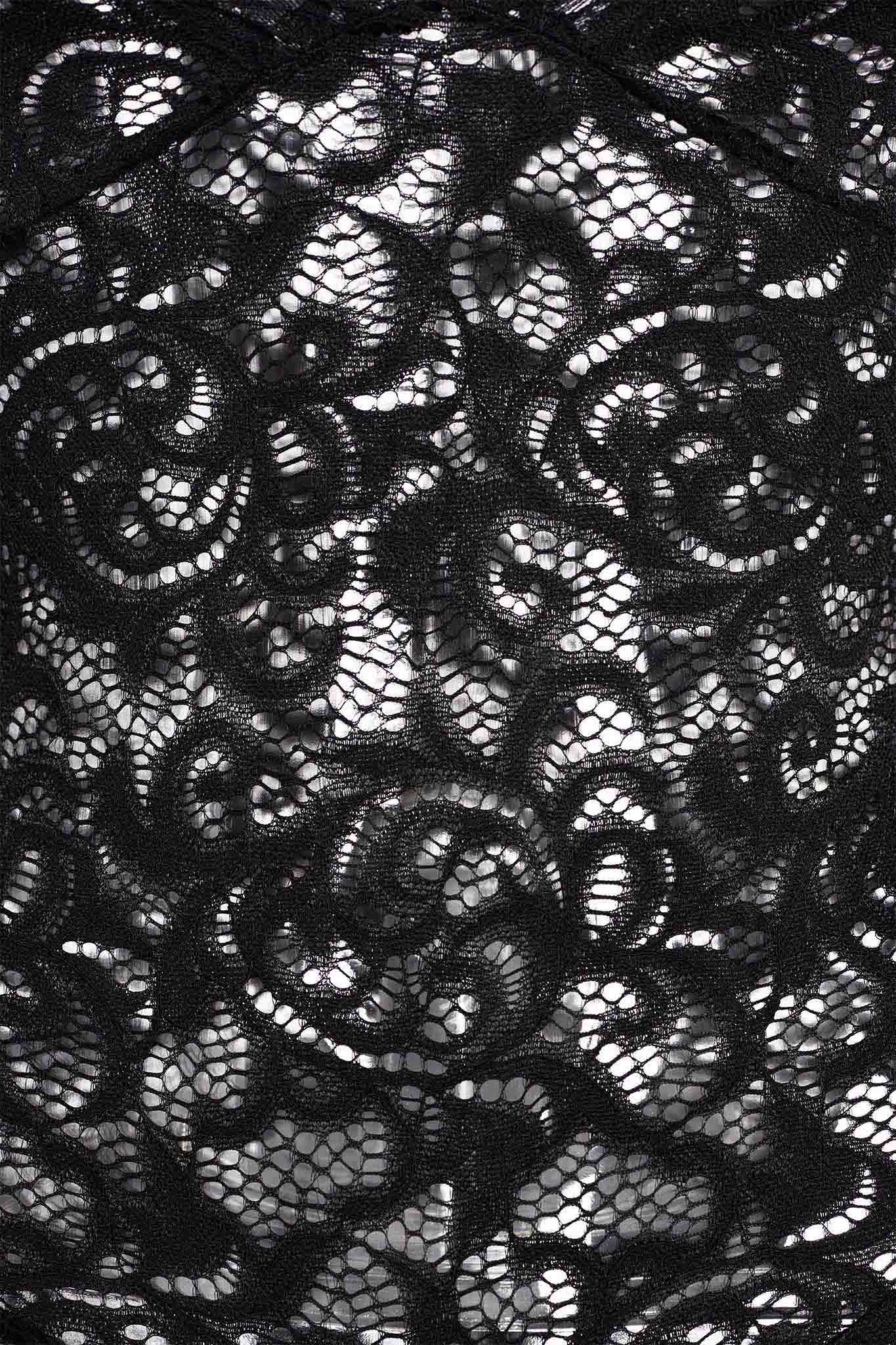 Close-up of the GEMMA ROMPER - BLACK, featuring intricate floral patterns that epitomize I.AM.GIA's signature style. This black lace fabric showcases a sheer, delicate quality with a blend of solid and mesh-like areas that highlight its detailed craftsmanship. The white background behind the romper enhances and highlights its design perfectly.