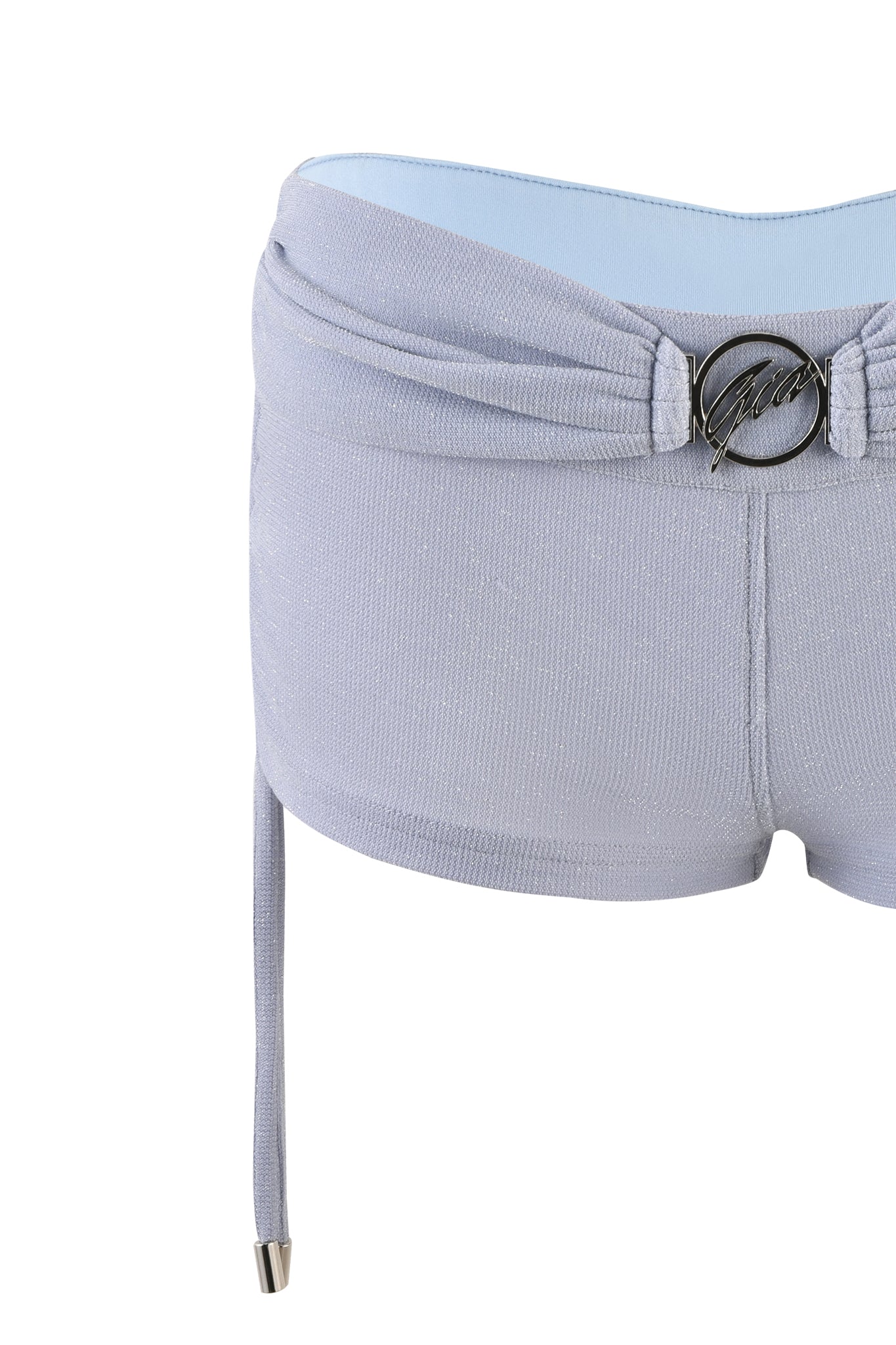 Women's shorts in baby blue by I.AM.GIA, known as the KAYNA SHORT, featuring a fold-over waistband with a decorative metal buckle detail in the front. A string hangs from one side of the waistband. The fabric appears soft with a slight shimmer.
