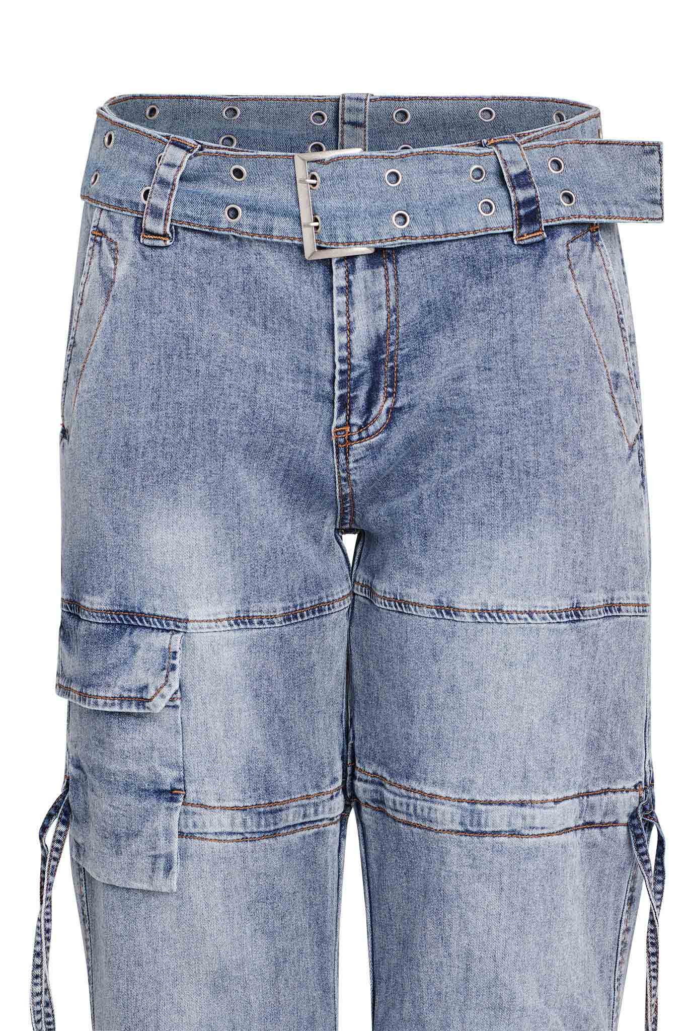 A close-up image of the NAIMA CARGO PANT - DENIM, designed by I.AM.GIA, showcasing a pair of light blue denim cargo jeans with multiple pockets and a coordinating denim belt adorned with metal eyelets. The jeans feature visible stitching and a slightly distressed look.