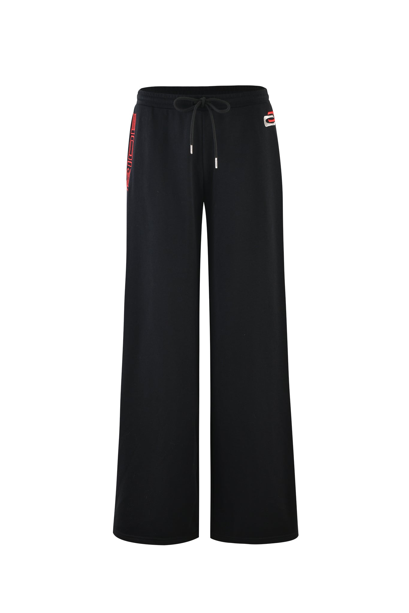 Introducing the JUSTINE PANT - BLACK by I.AM.GIA: A pair of black baggy track pants featuring an elastic drawstring waistband. These pants are adorned with minimalistic red and white GIA embroidery near the waistband on both sides. Crafted from a soft and comfortable fabric, they are perfect for achieving a casual yet stylish look.
