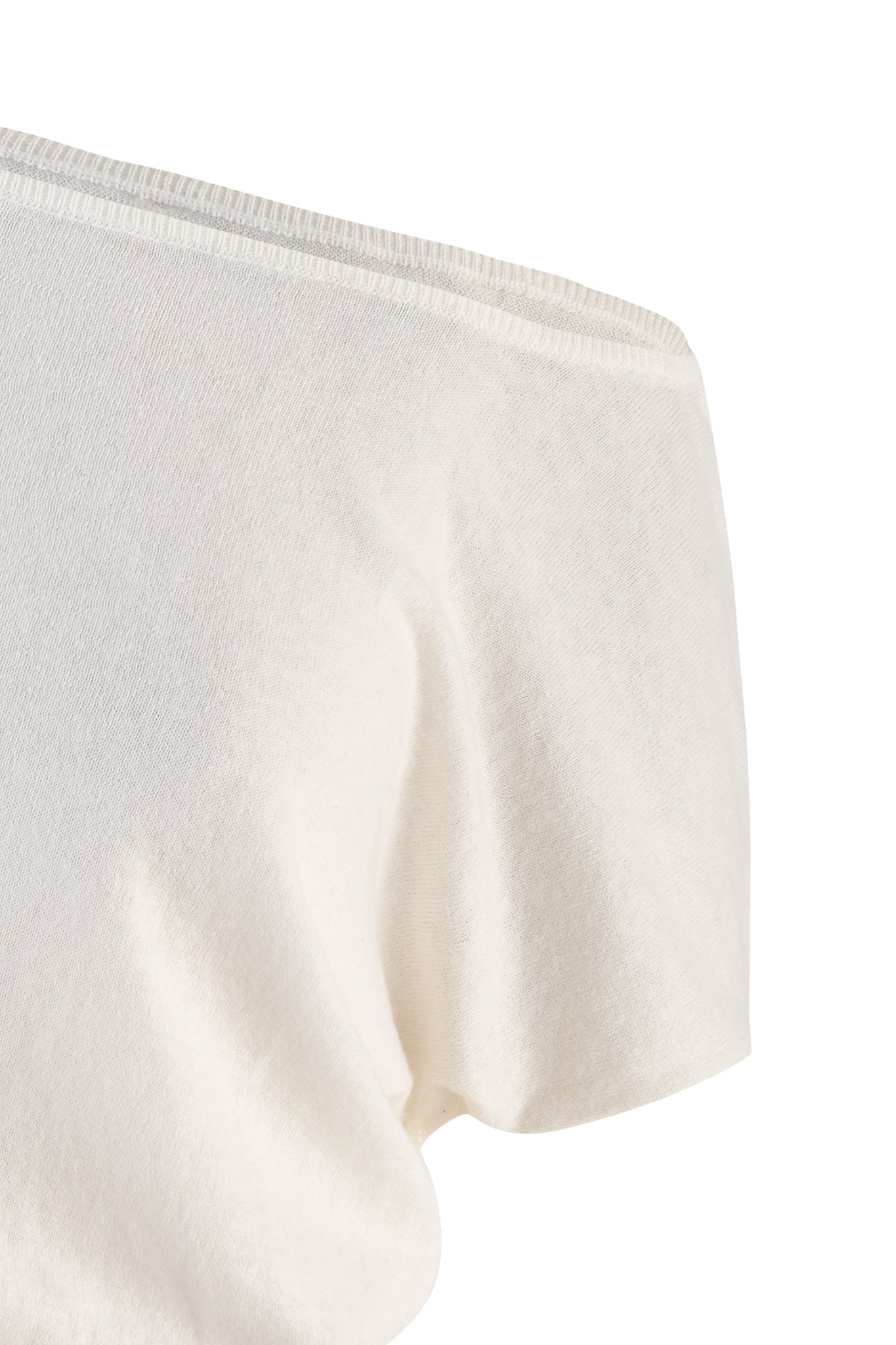 Close-up of the GISELLE SHORT SLEEVE TOP - WHITE by I.AM.GIA, made from a soft fabric. The image focuses on the shoulder seam and part of the sleeve, highlighting the ribbed detail that enhances the texture and quality of the material. The shirt appears simple and casual.
