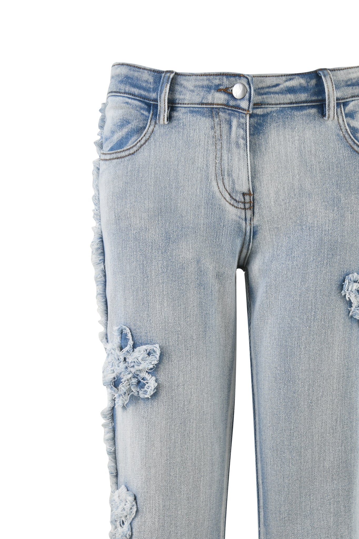 Close-up of the TYLA JEAN - BLUE denim jeans from I.AM.GIA. The light-wash, distressed jeans feature a frayed hem along the side seam and torn, patch-like details along the thighs. The waistband includes a metal button and zipper closure, with visible front pockets and stitching.