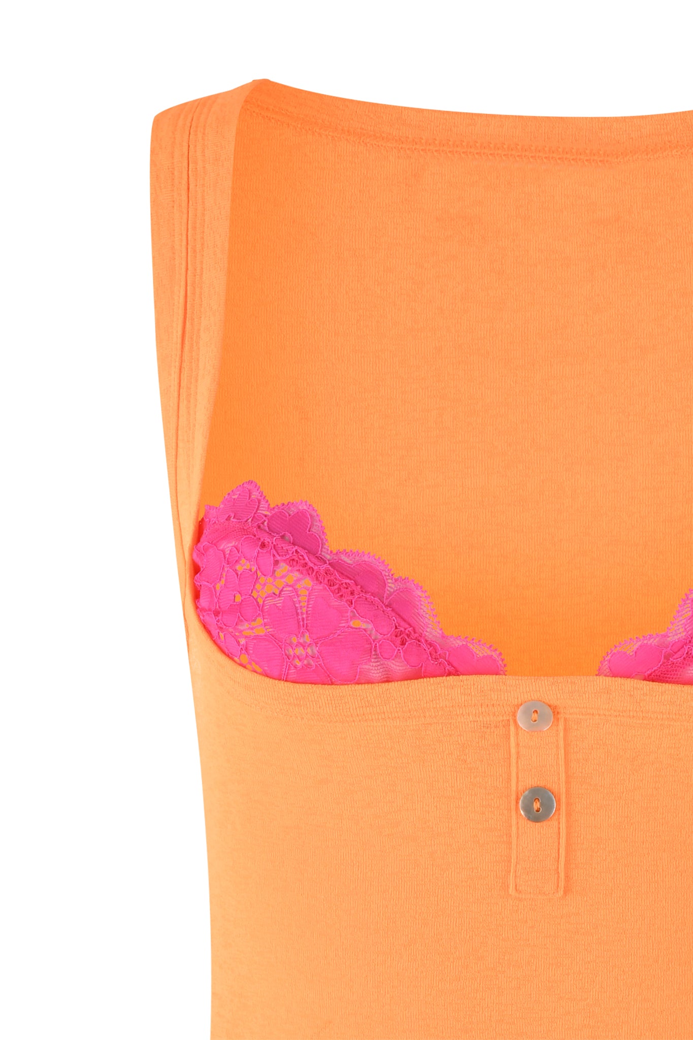 Close-up of the Pippa Mini Dress in orange and apricot by I.AM.GIA, featuring two buttons at the front, worn over a pink lace bra. Only the upper portion of the garment is visible, with its vibrant colors strikingly contrasting each other.