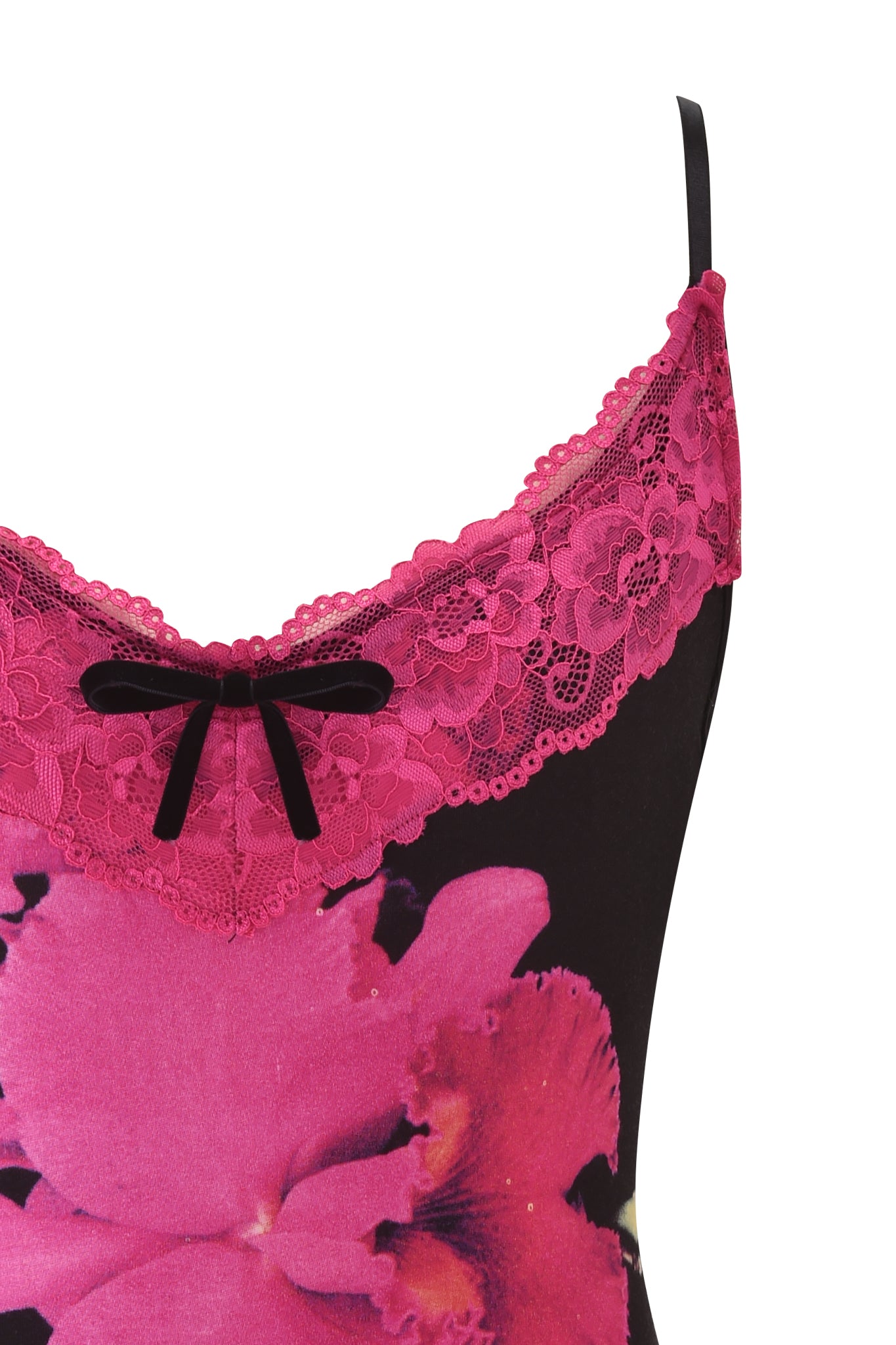 Close-up of the I.AM.GIA ADELLA TOP - FUCHSIA, a black cami with thin straps, bright pink lace trim at the neckline, a central black bow, and bold fuchsia floral print on the fabric.