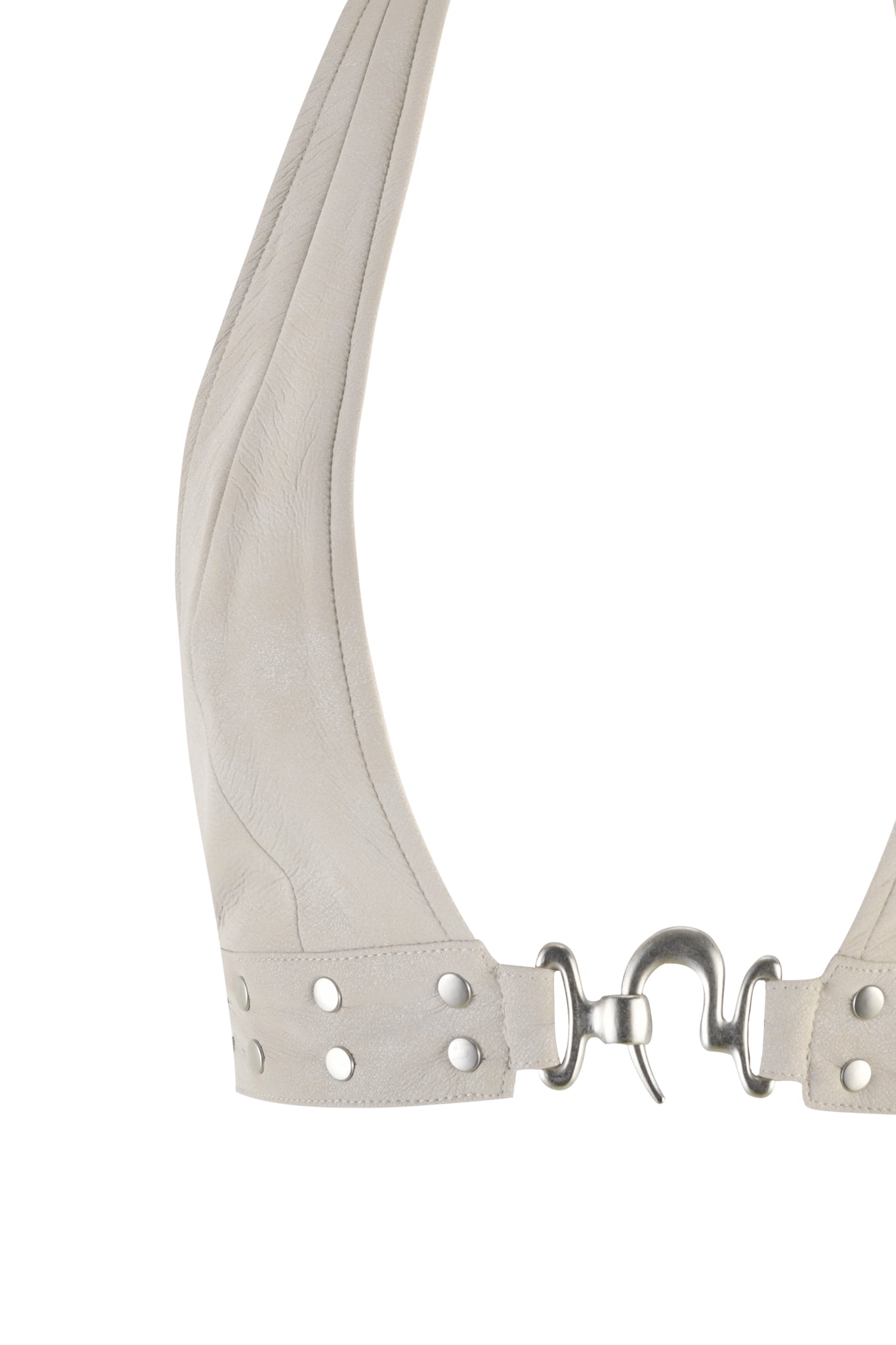 A close-up image of a beige leather belt with metal rivets and a silver hook clasp. The belt appears to be laid flat, showcasing its texture and hardware details, reminiscent of the intricate craftsmanship seen in the DOLLY TOP - NEUTRAL : TAN by I.AM.GIA.