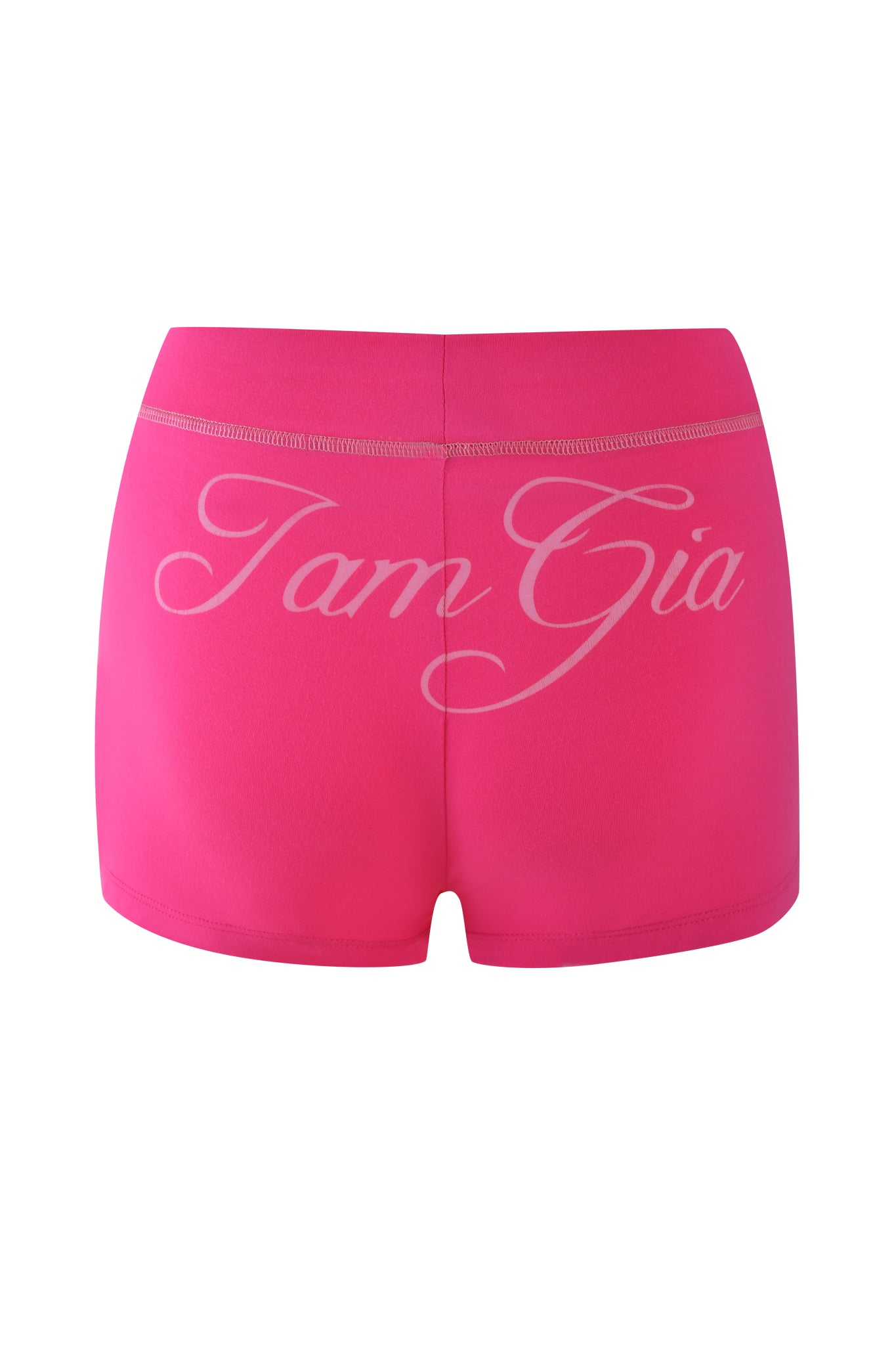 BLARE SHORT - PINK from I.AM.GIA are hot pink athletic shorts featuring "Tam Gia" in white cursive on the back. Made from stretchy bamboo fabric, they offer a smooth bodycon fit for sports or casual wear.