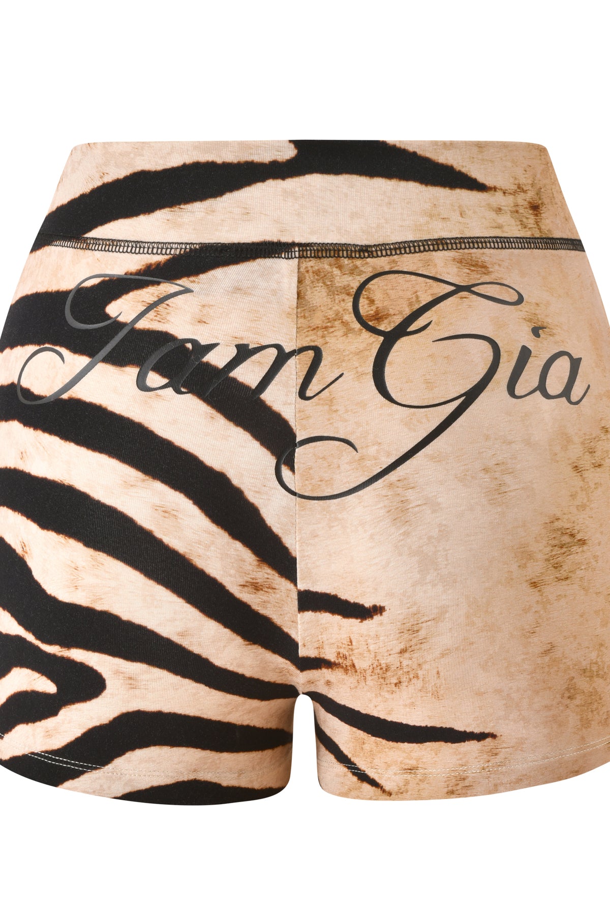 The BLARE SHORT - WILD SIDE by I.AM.GIA features a high-waisted elastic waistband, a striking tan zebra print, and “I.AM.GIA” boldly written in large cursive script across the back.