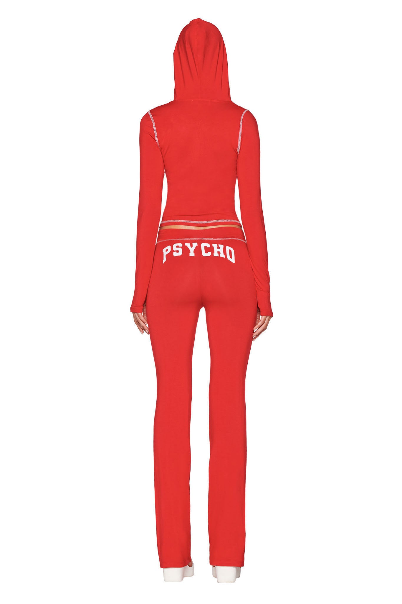 A person is seen from behind wearing I.AM.GIA's BLARE TRACKPANT - RED : PSYCHO : SALSA, a low-rise, red hooded tracksuit with "PSYCHO" in bold white letters across the back.