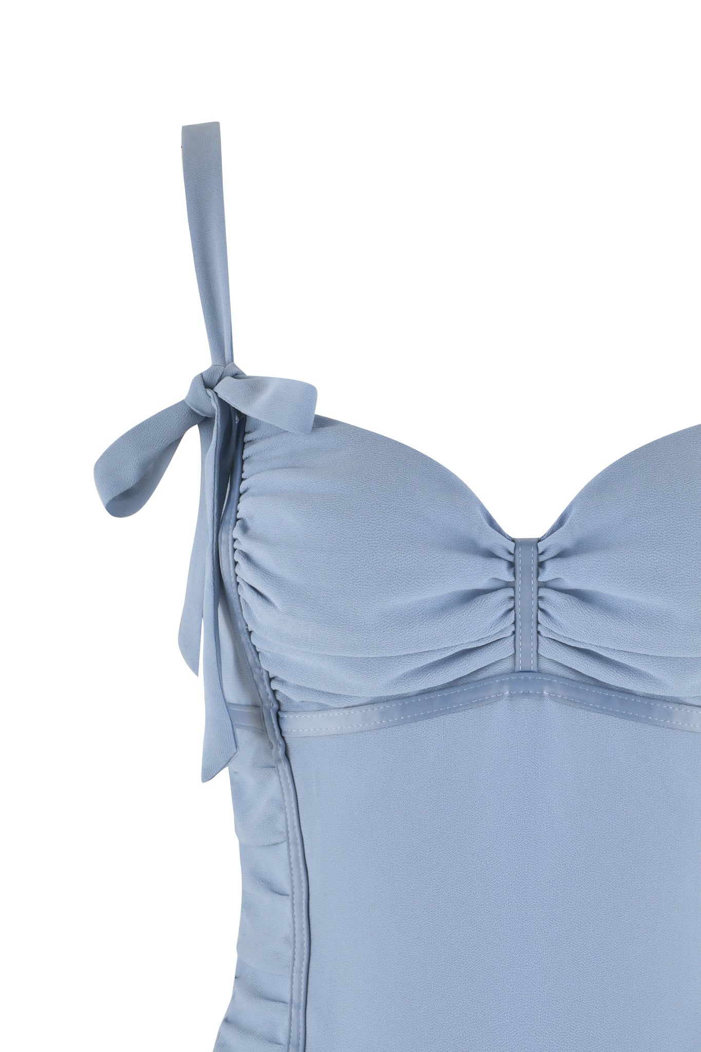 Close-up of the QUEENIE TOP - BLUE in Steel Blue by I.AM.GIA, showcasing a sweetheart neckline with gathered fabric and a bow detail on the strap. The georgette bodice adds texture, while maintaining an elegant and feminine style.