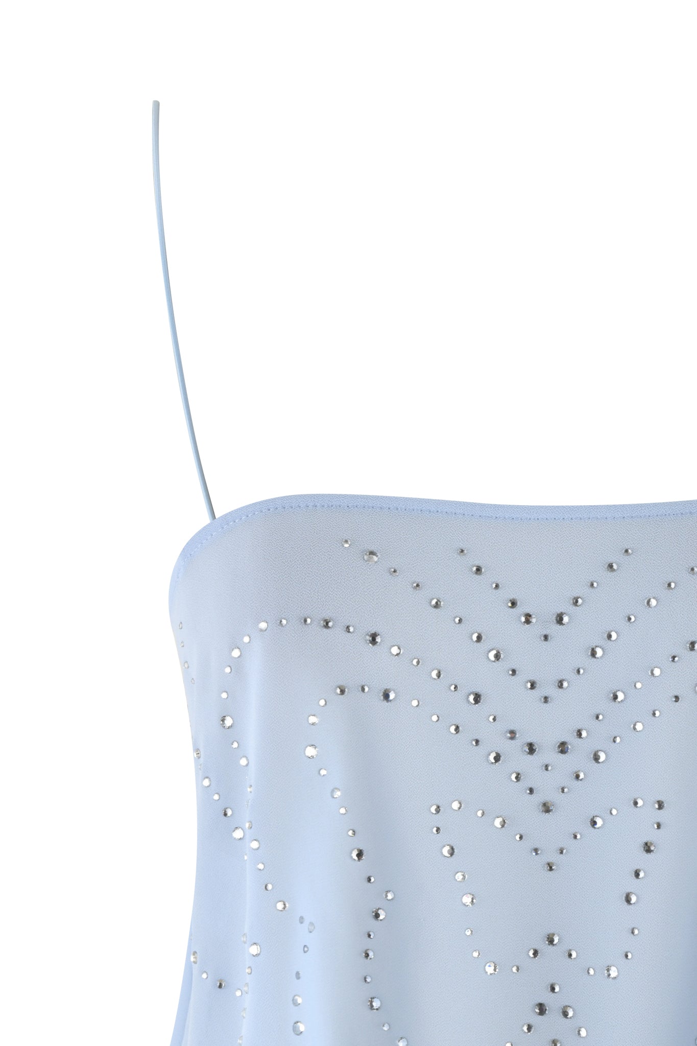 The MINA TOP - BLUE by I.AM.GIA in baby blue is a semi-sheer georgette style with a single thin strap and embellished with silver studs, forming a butterfly diamante design for an elegant and whimsical look.