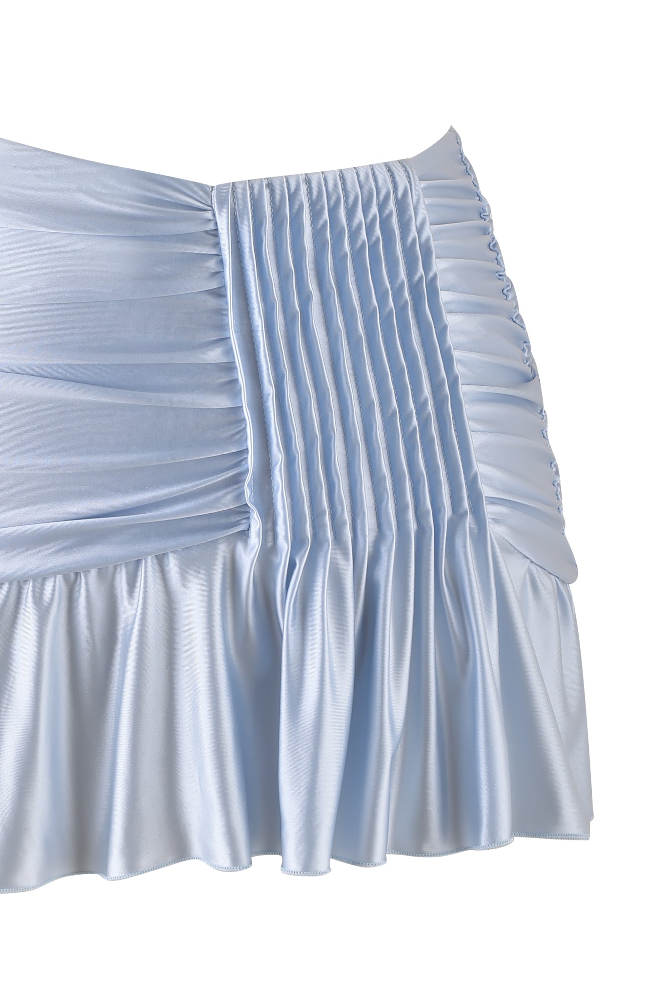 Here is a close-up of the ELYSIA MINI SKIRT in baby blue by I.AM.GIA, showcasing its light blue satin fabric with elegant ruching and pleats. The shiny satin knit offers a smooth texture, while the ruffled edges contribute to its sophisticated appearance.