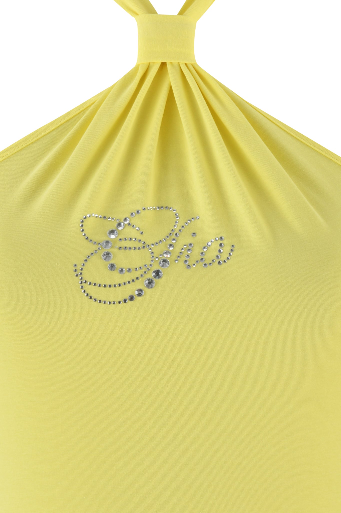 Close-up of the ROWAN TOP - YELLOW by I.AM.GIA, featuring rhinestones spelling "Cha" on a baby yellow halter top. The bamboo fabric is gathered at the top for a draping effect.