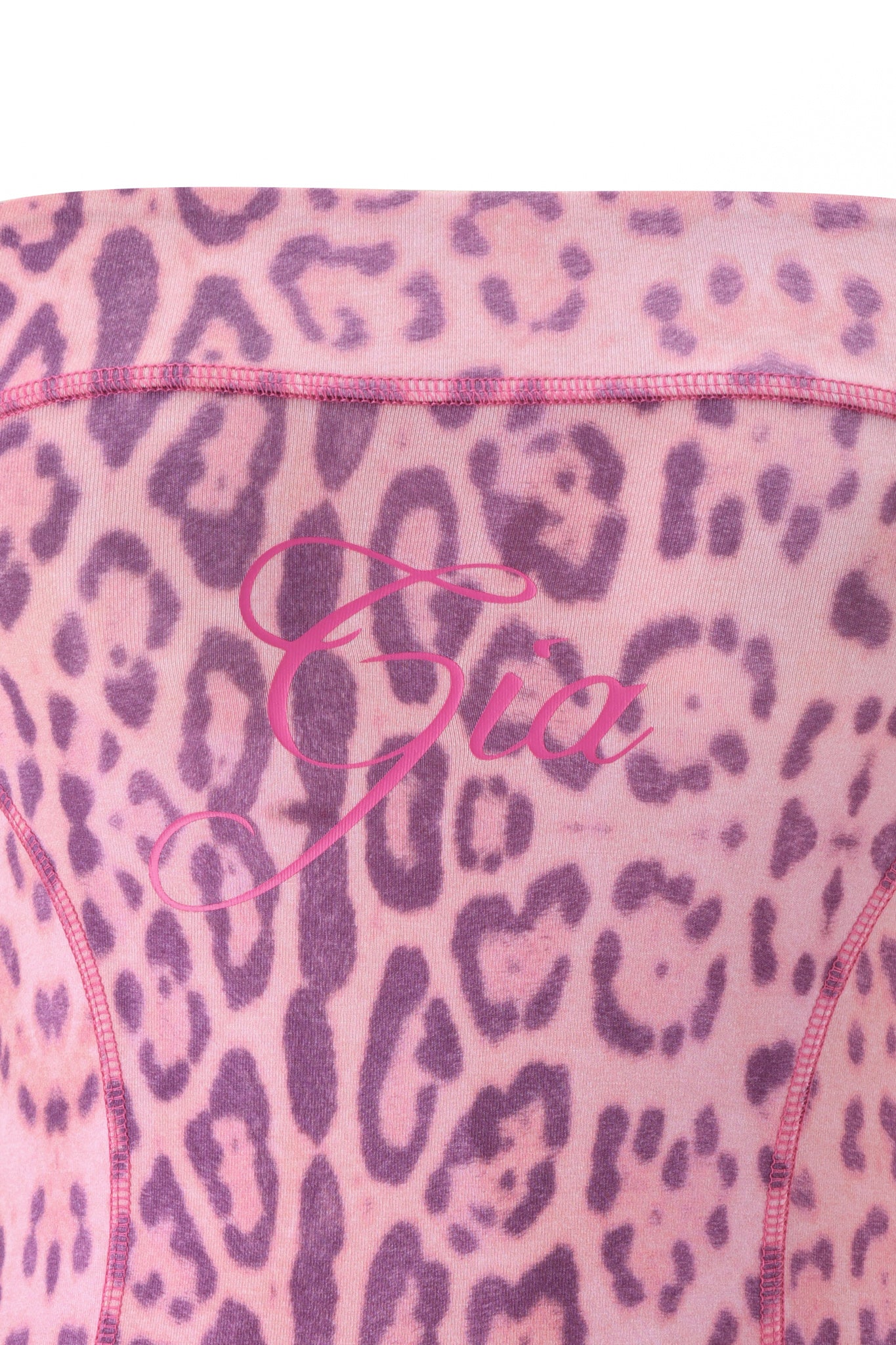 A close-up of the BLARE BOOB TUBE - PINK PANTHERA by I.AM.GIA, featuring pink and purple Panthera print fabric with “Gia” written in pink cursive across the center.