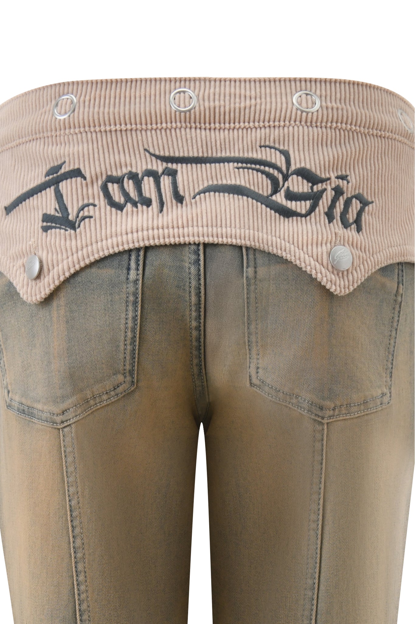 Close-up of I.AM.GIA TOMMIE JEAN - ANTIQUE DENIM flared pants with a beige corduroy waistband, black embroidered script, visible silver buttons, mid-rise waist, faded finish, and two back pockets.