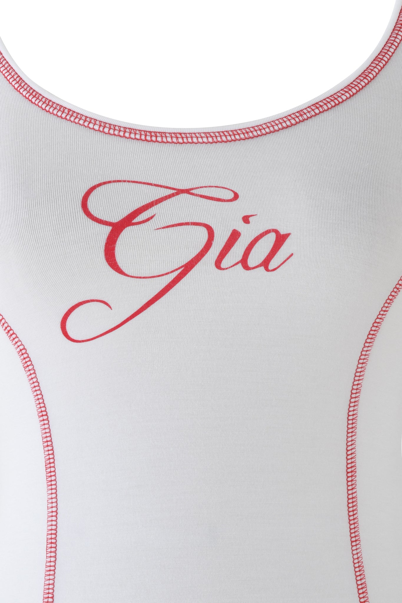 A close-up of the BLARE TANK - WHITE by I.AM.GIA, a white bodycon tank top with bold red "Gia" script across the chest and red stitching accenting the seams and neckline.