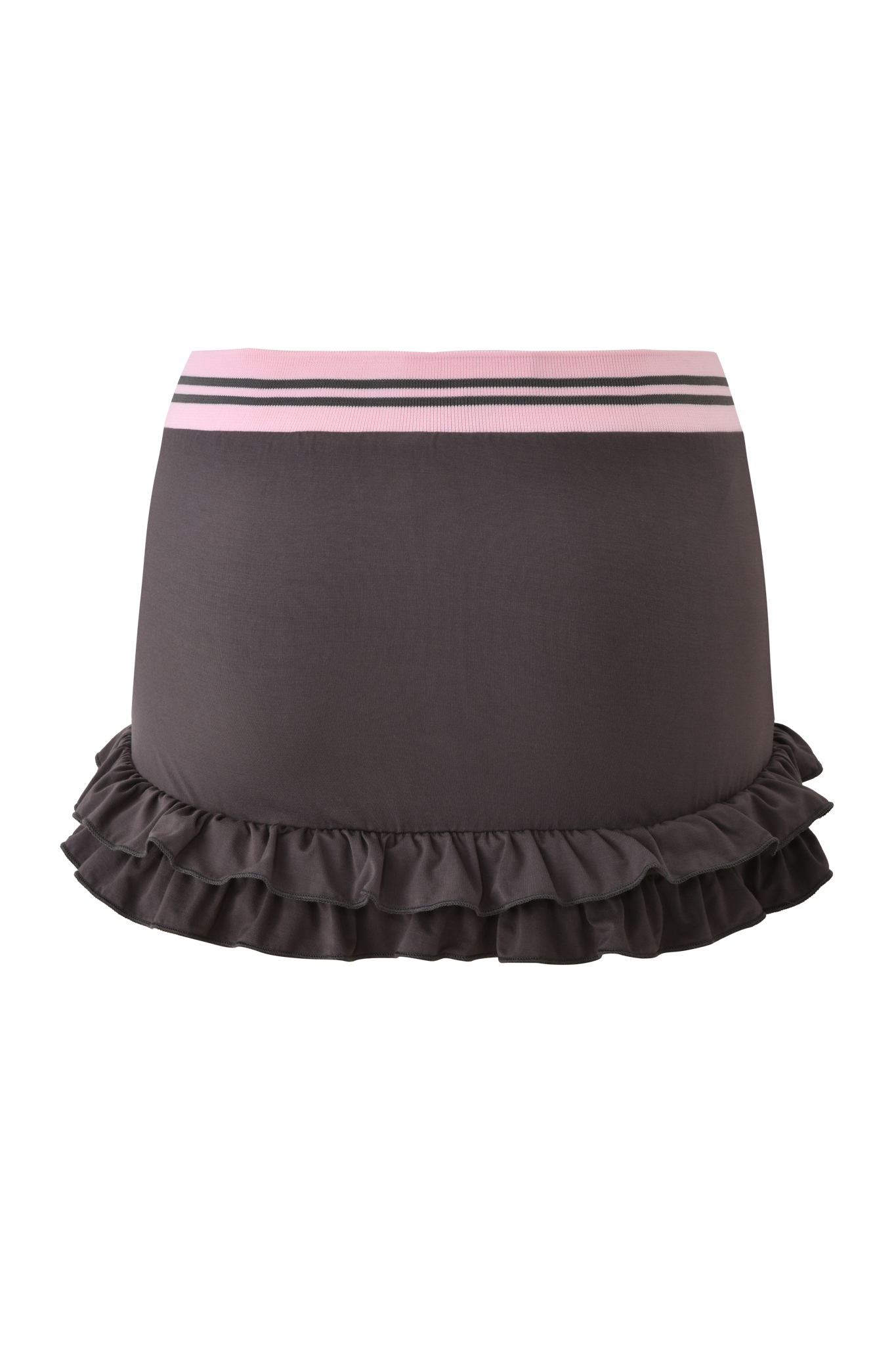 The I.AM.GIA ELLIS SKORT - GREY is a charcoal grey mini skort with layered ruffles and a bubblegum pink elastic waistband accented by two slim stripes, set against a pink gradient background.